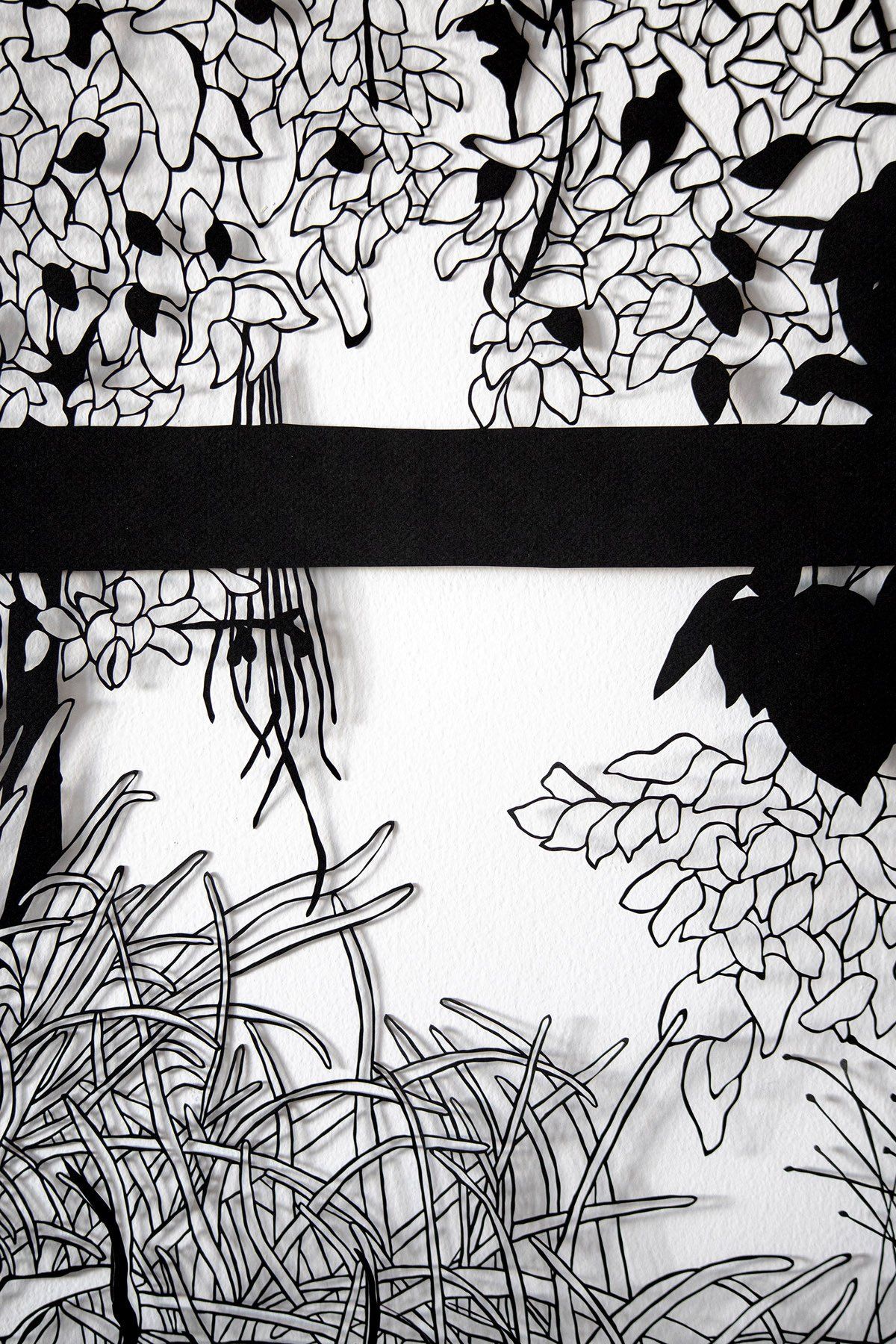 A black and white drawing of trees and grass