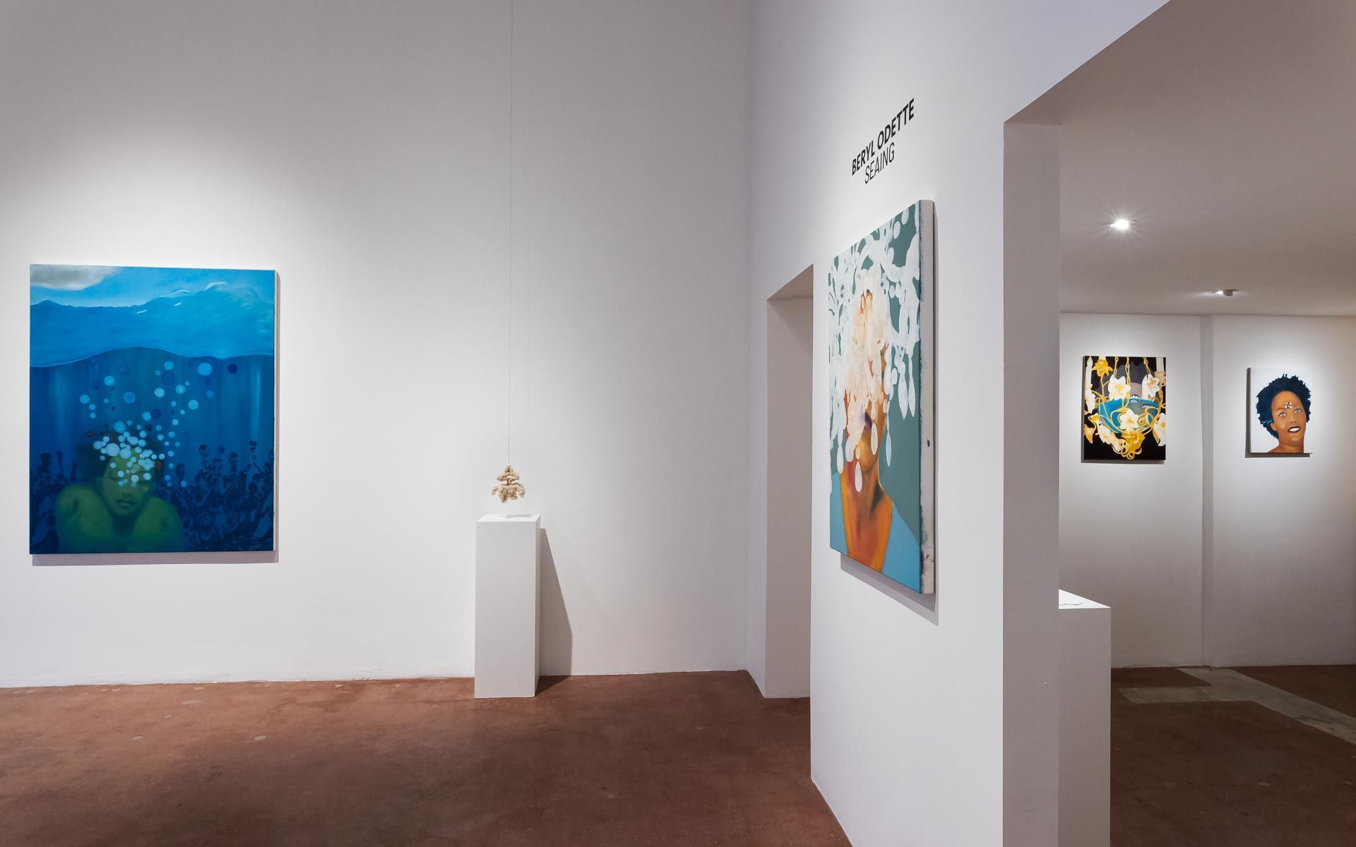 White-walled art gallery with several colorful paintings and a small sculpture on a pedestal. Beryl Odette art exhibition at Track 16 East Hollywood gallery. Paintings and Sculptures, exhibit titled SEAING.