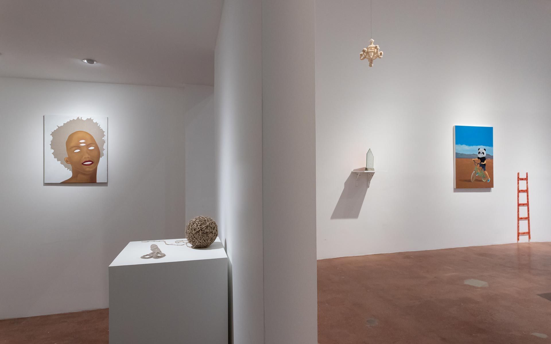 Painting of a white flower at left and a portrait of a woman with white hair on the back wall, a woven ceramic sphere on a white pedestal. Installation view, Beryl Odette: Seaing, Track 16.