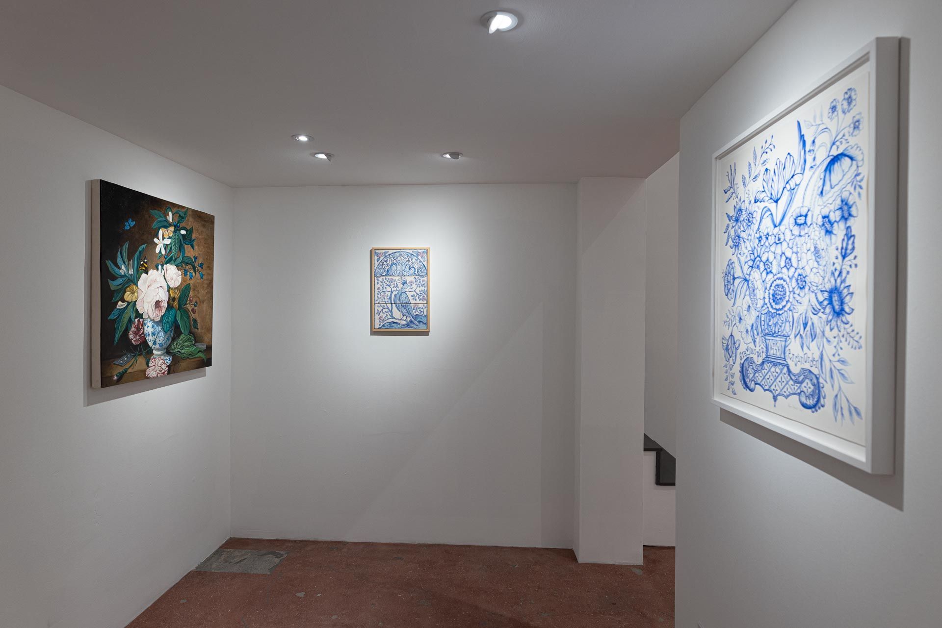 White gallery hallway with three framed artworks on white walls and recessed ceiling lights. Elyse Pignolet art exhibition at Track 16 East Hollywood gallery. Title, The Revolution Will Not Be Televised featuring ceramic works and drawings.