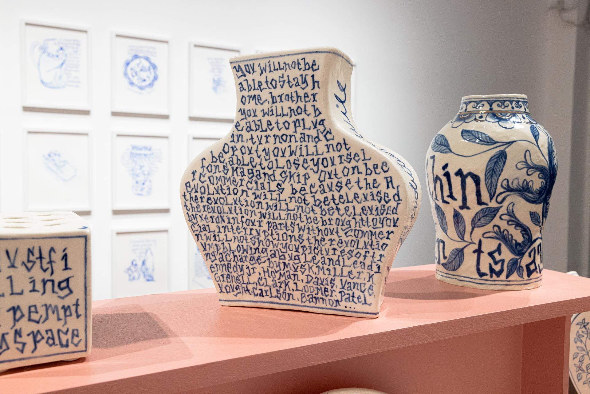 Three blue-and-white ceramic vases displayed on a shelf in a gallery. Elyse Pignolet art exhibition at Track 16 East Hollywood gallery. Title, The Revolution Will Not Be Televised featuring ceramic works and drawings.