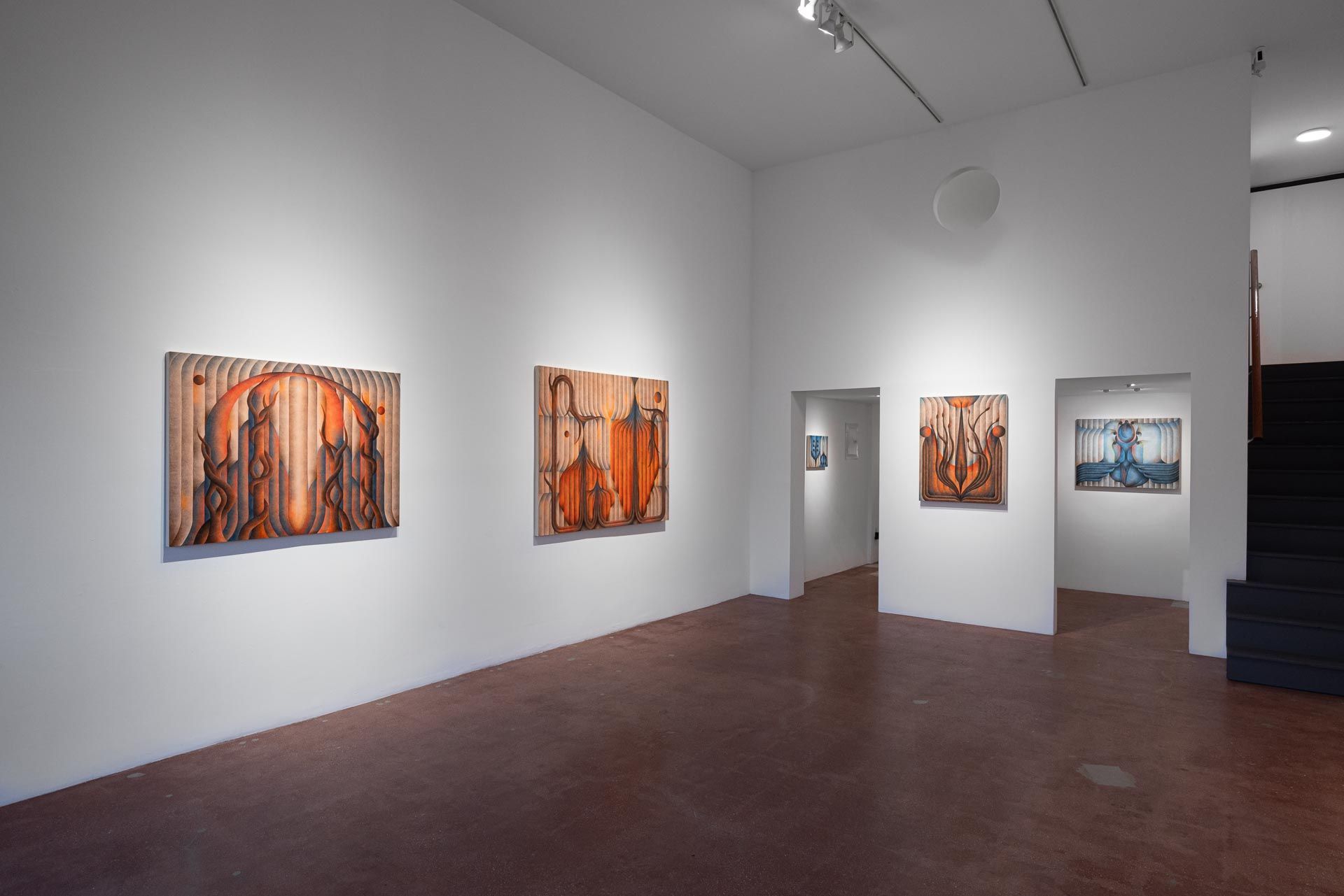 Orange paintings on a white wall, two doorways opening to more paintings. Installation view, Roberta Gentry: Blood Orange, Track 16, Los Angeles.