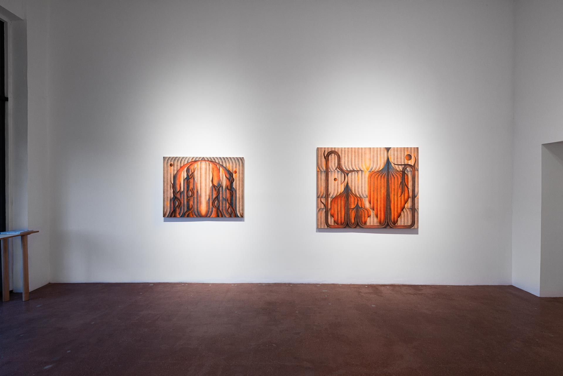 Two orange paintings side by side on a white wall above a brown floor. Installation view, Roberta Gentry: Blood Orange, Track 16, Los Angeles.