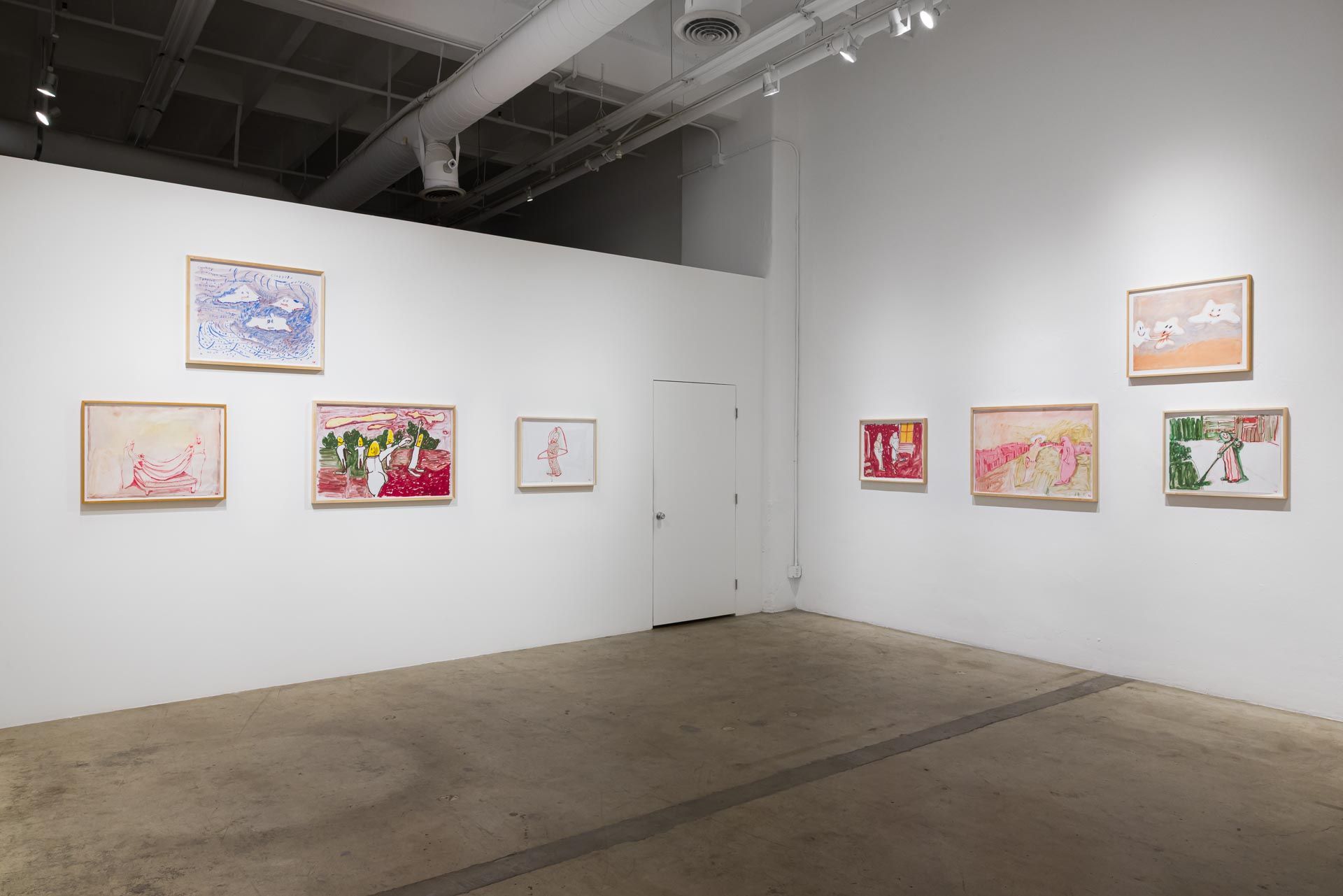 Framed drawings along two white walls with a white door between them, concrete floor and exposed ceiling. Installation view, Kathleen Henderson: Clappers, Track 16.