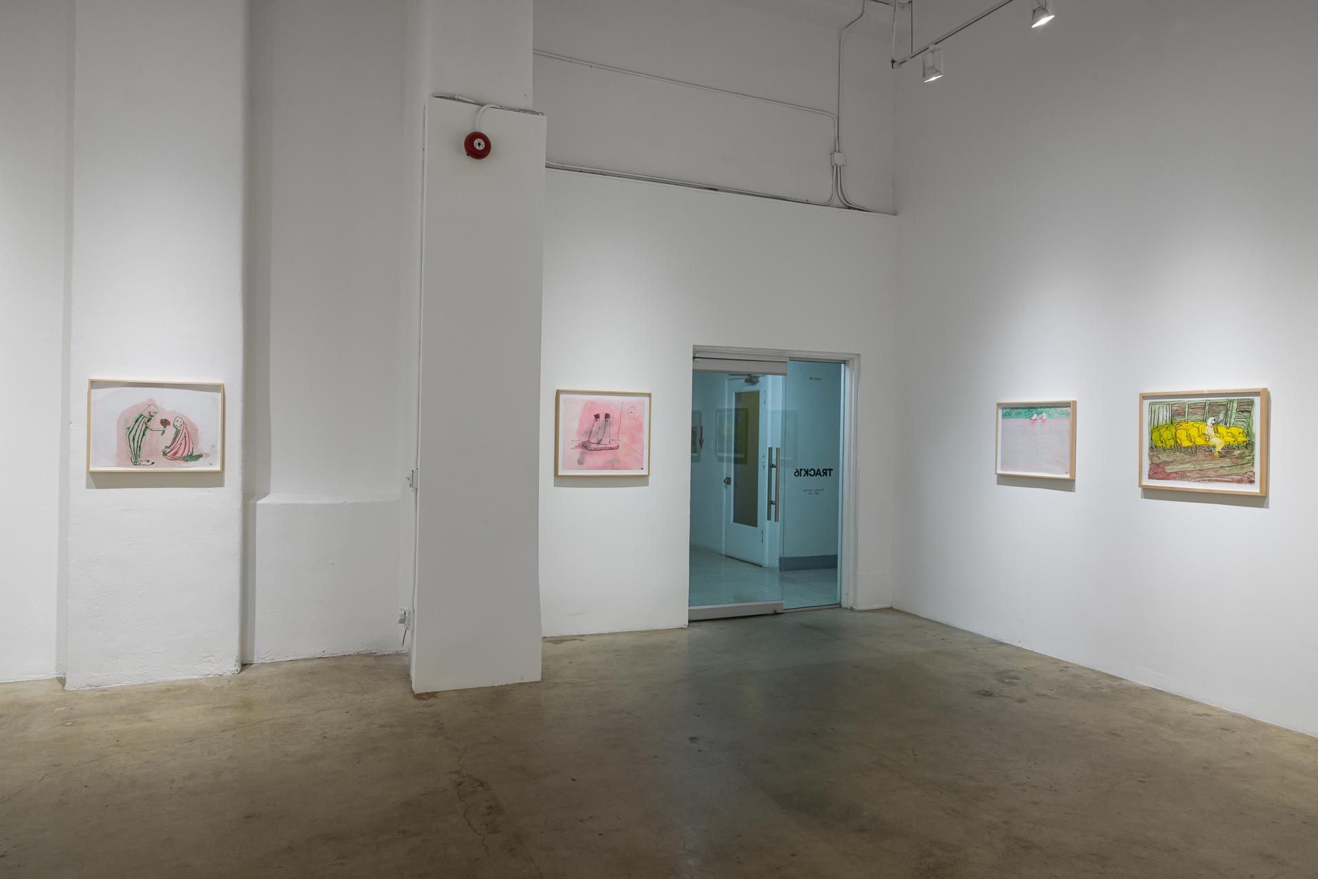 Small framed drawings on white walls around a column and a doorway, with a blue-lit room beyond. Installation view, Kathleen Henderson: Clappers, Track 16.
