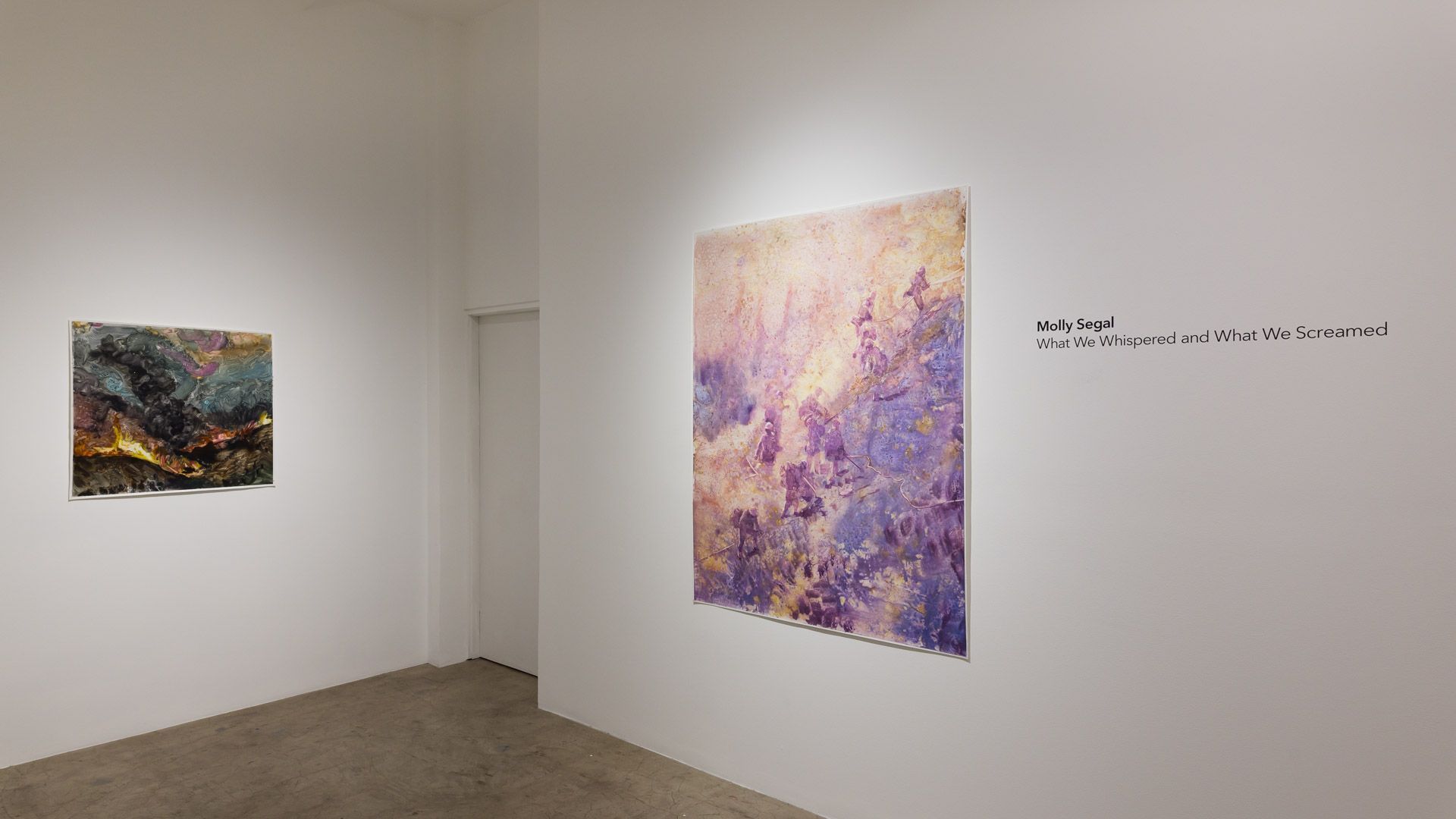 There are two paintings on the wall in a room.