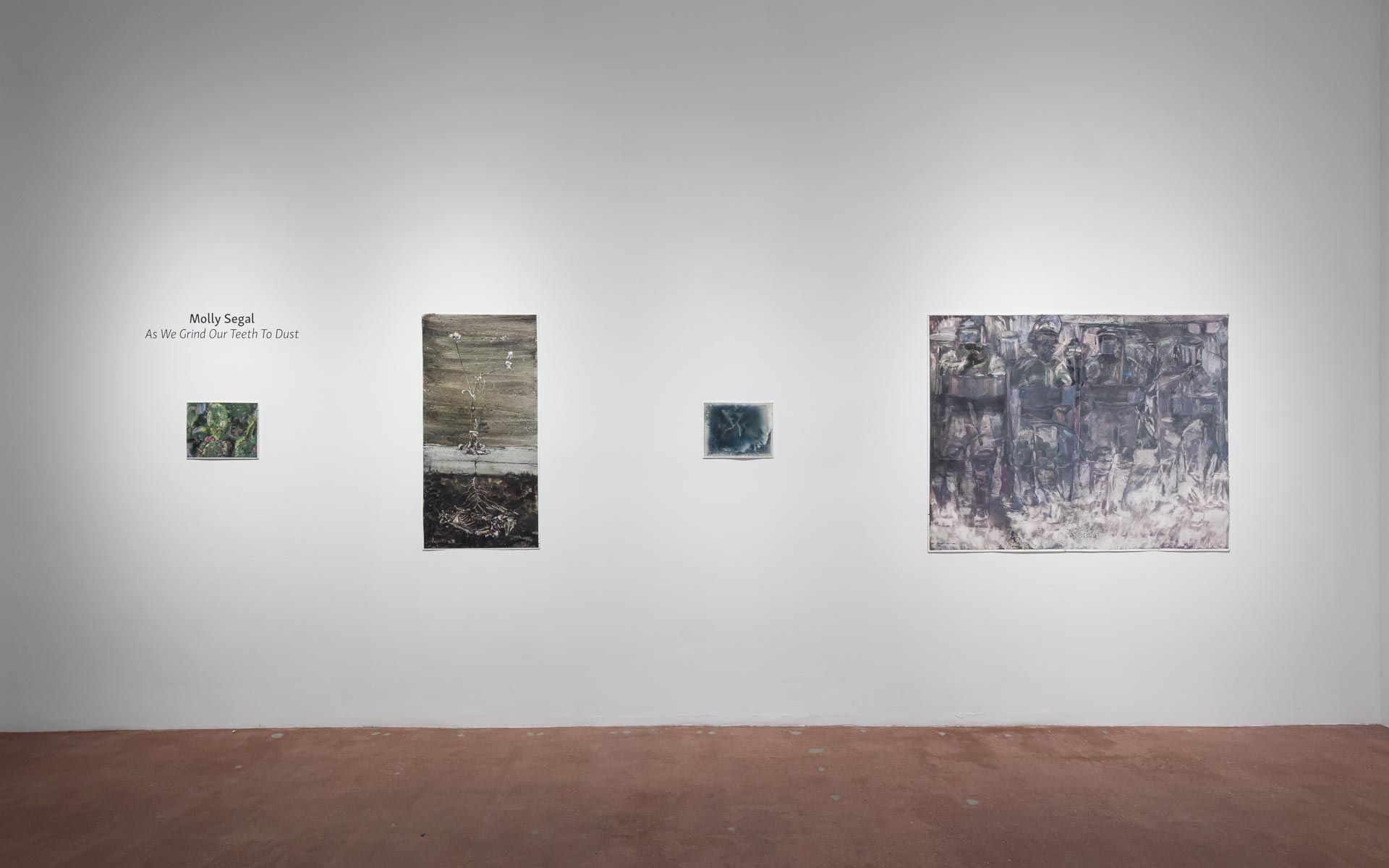 Several small dark and green paintings clustered at left and center, with a large gray-green painting of an animal form at right. Installation view, Molly Segal: As We Grind Our Teeth To Dust, Track 16.