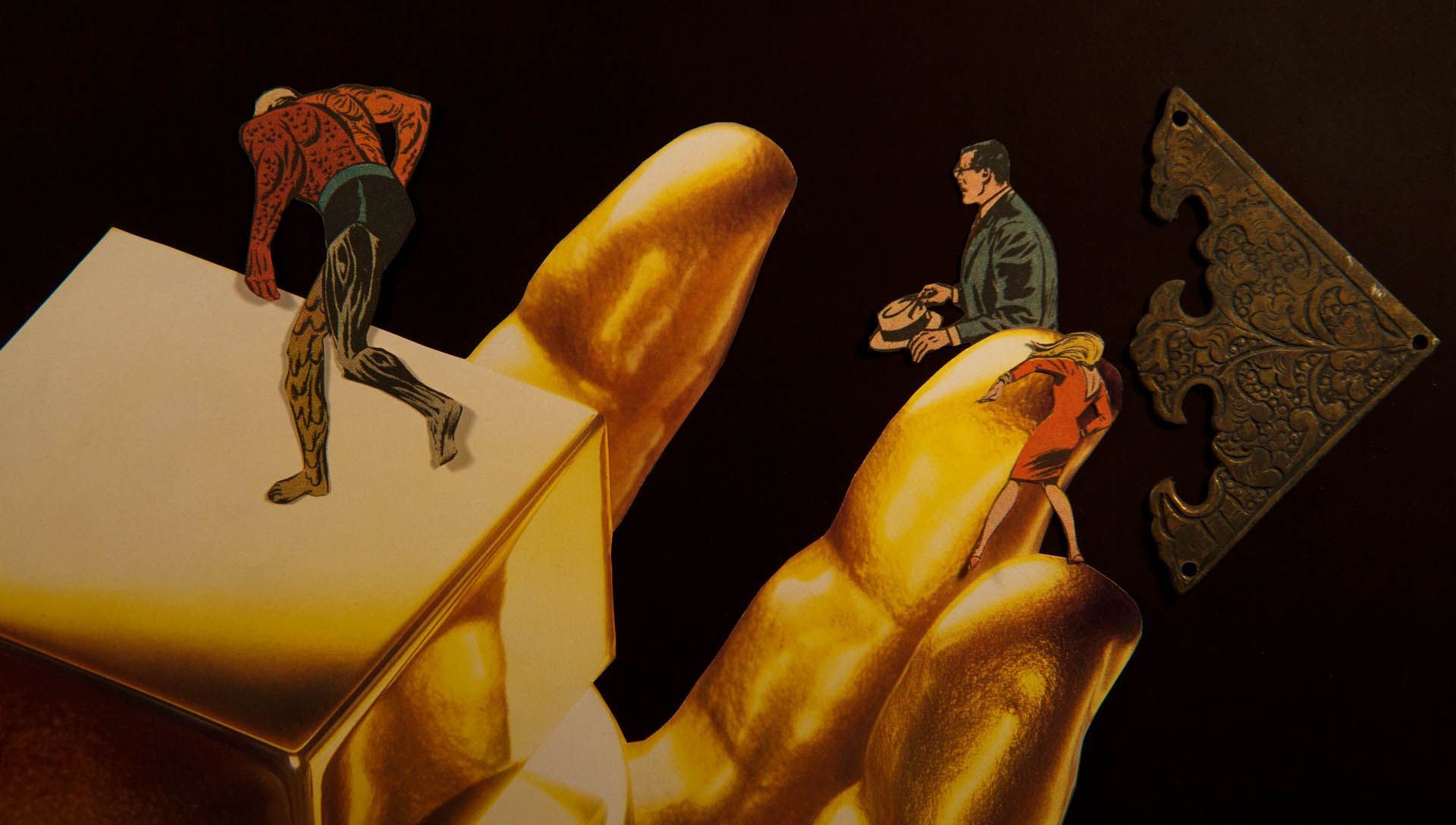A gold hand is holding a gold cube and a key