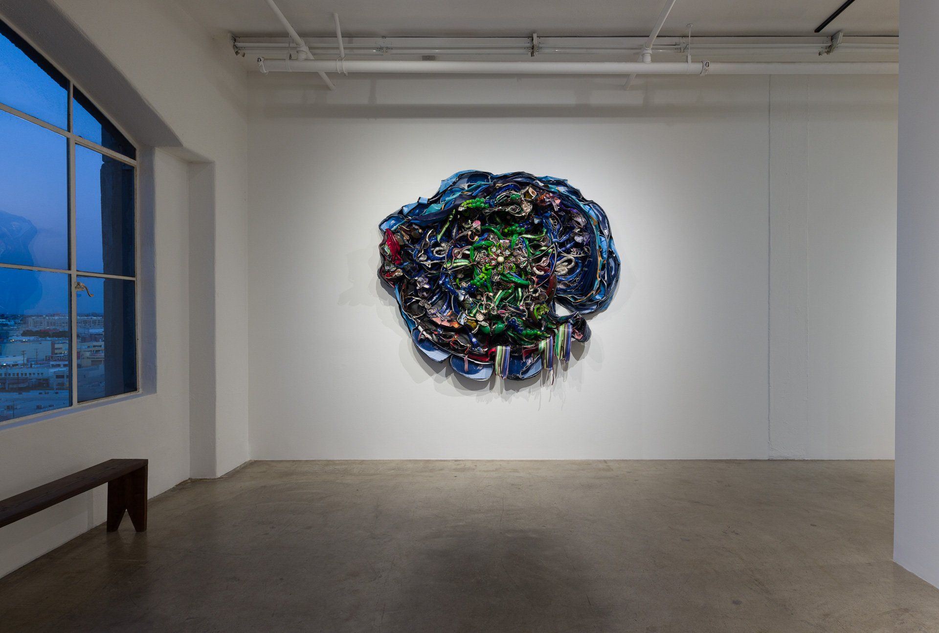 There is a large painting on the wall in the middle of the room.