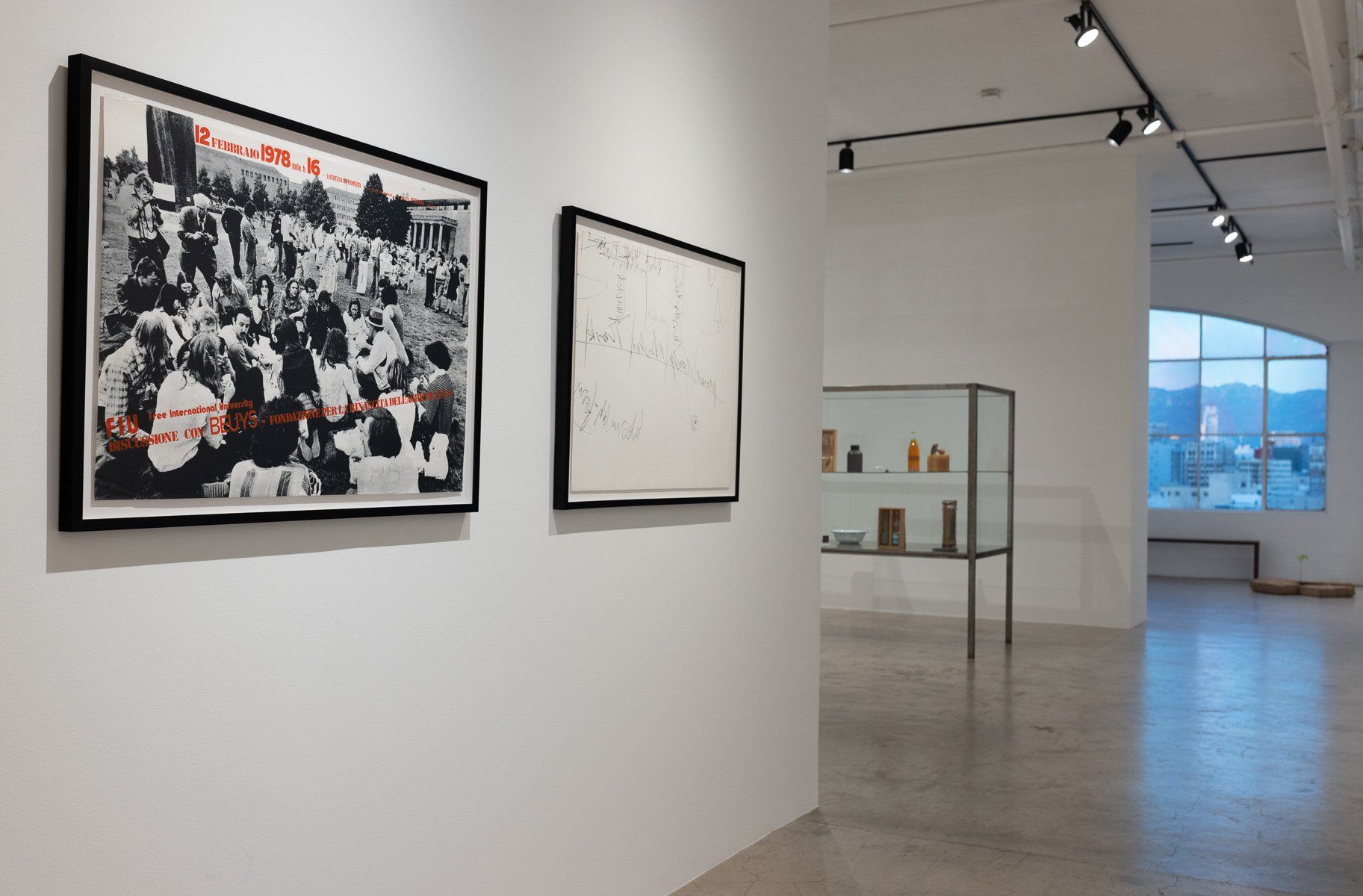 Two framed pictures are hanging on a wall in Track 16 Gallery.