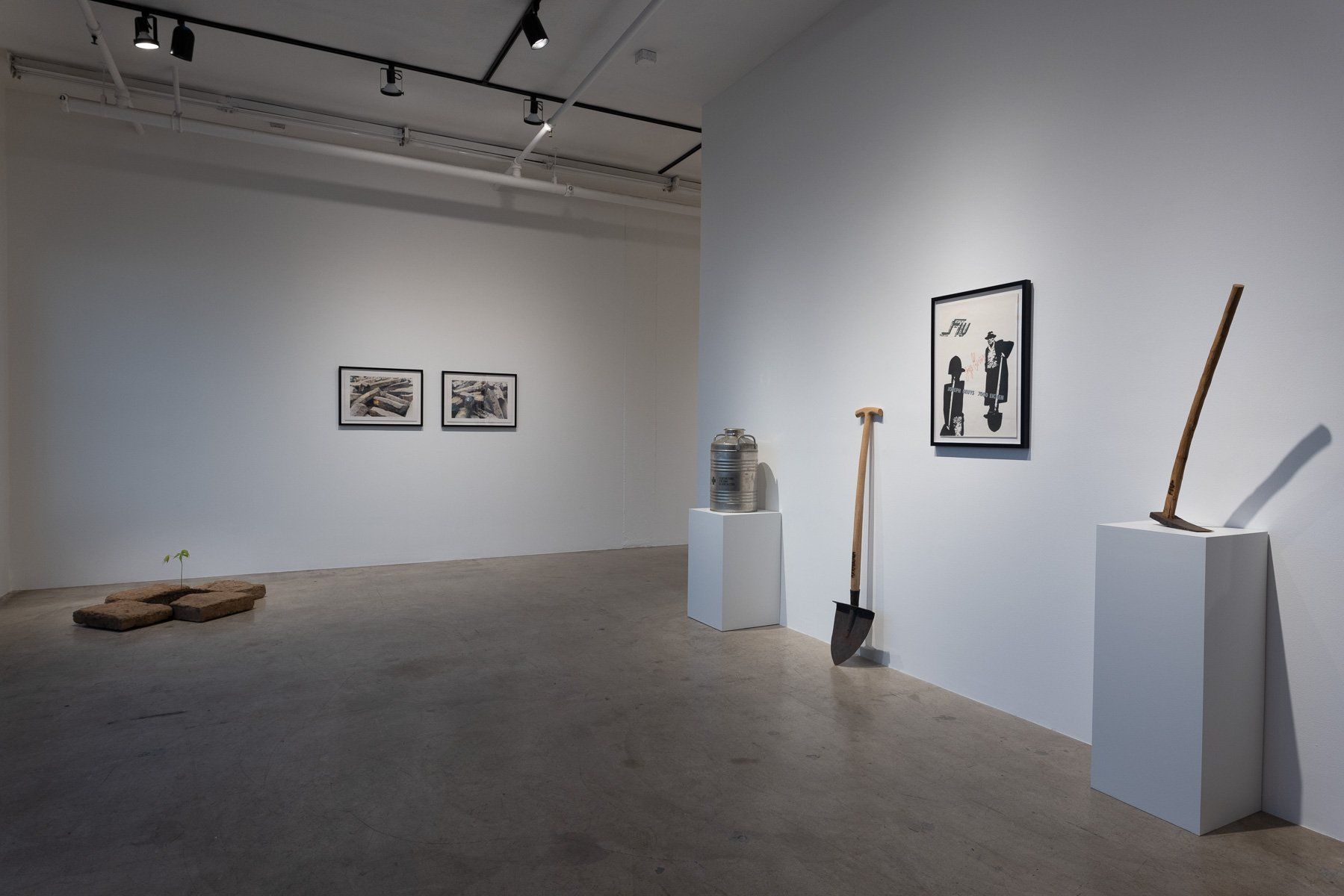 A room with a shovel and a stick on display