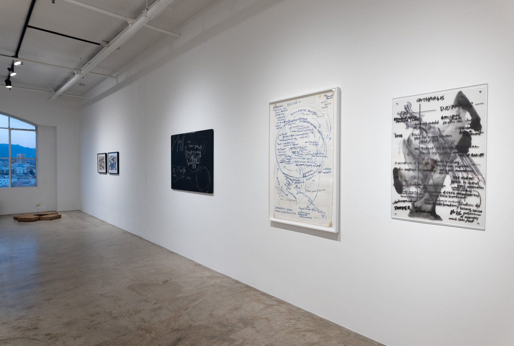 A room with a lot of paintings on the wall.