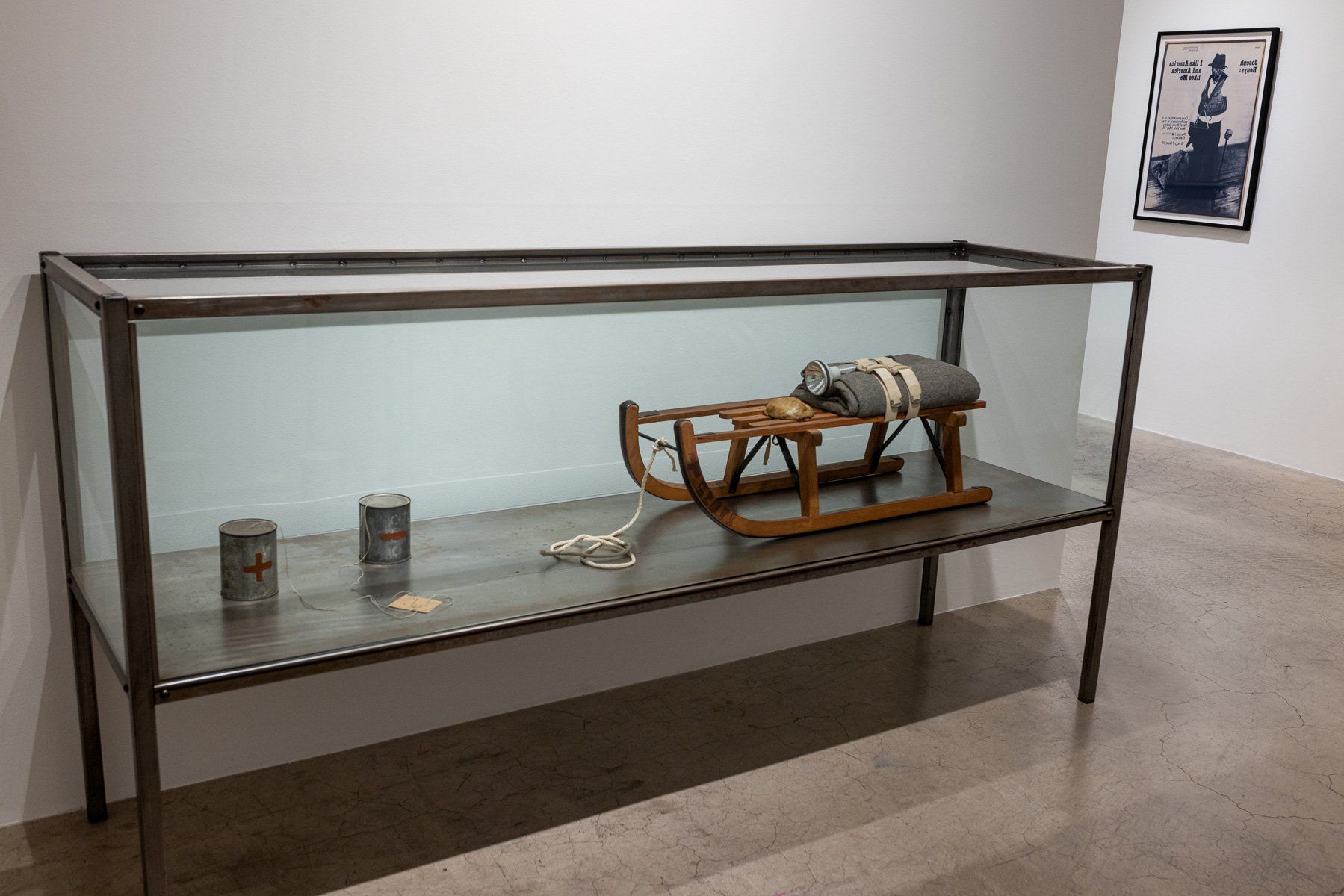 A sled is sitting on top of a glass display case in Track 16 Gallery.