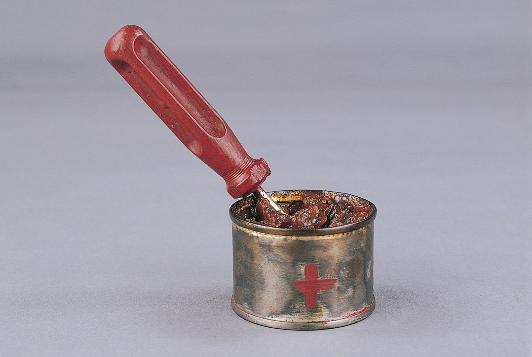 A can with a red handle and a red cross on it