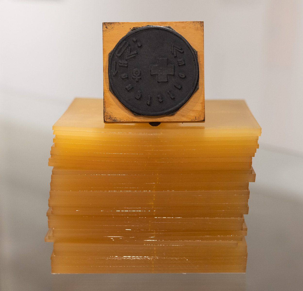 A stack of acrylic blocks with a stamp on top of them
