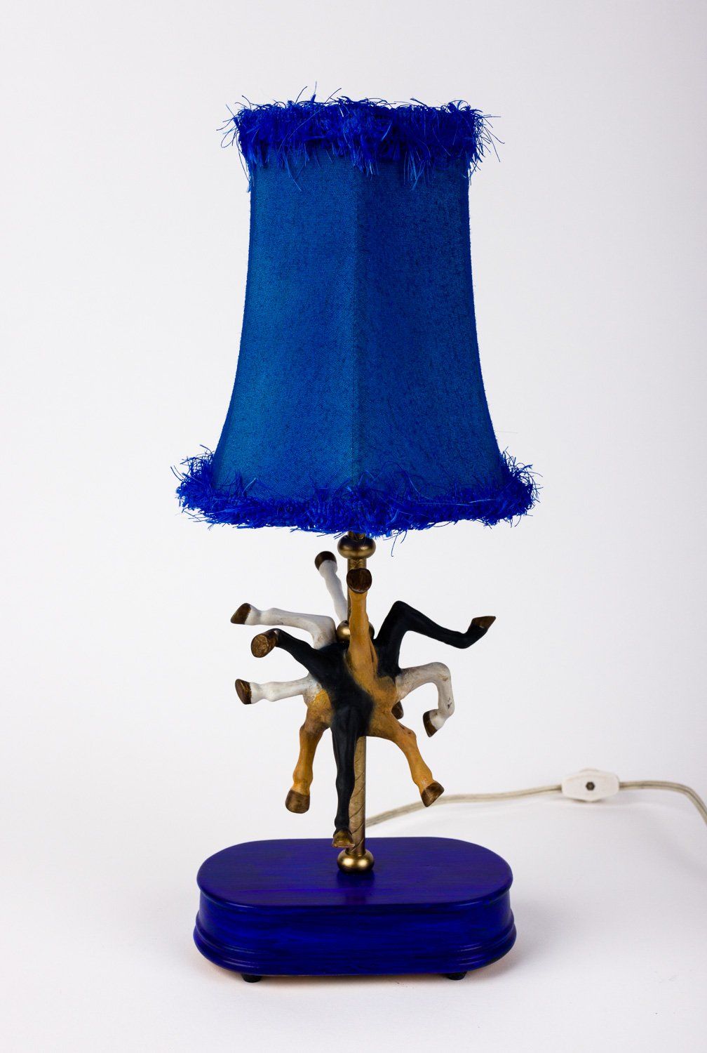 A lamp with a blue shade and a blue base