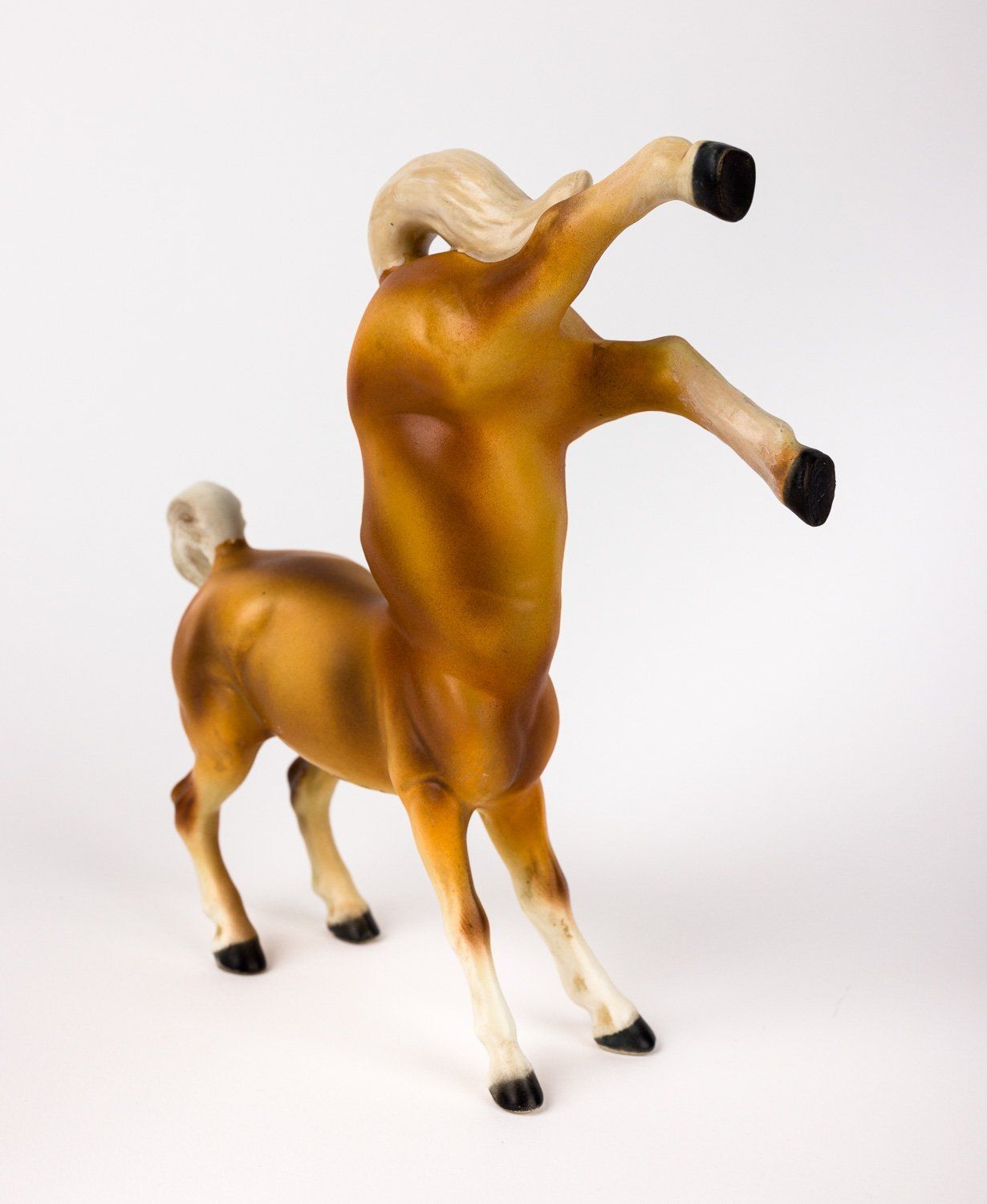 A figurine of a horse standing on its hind legs