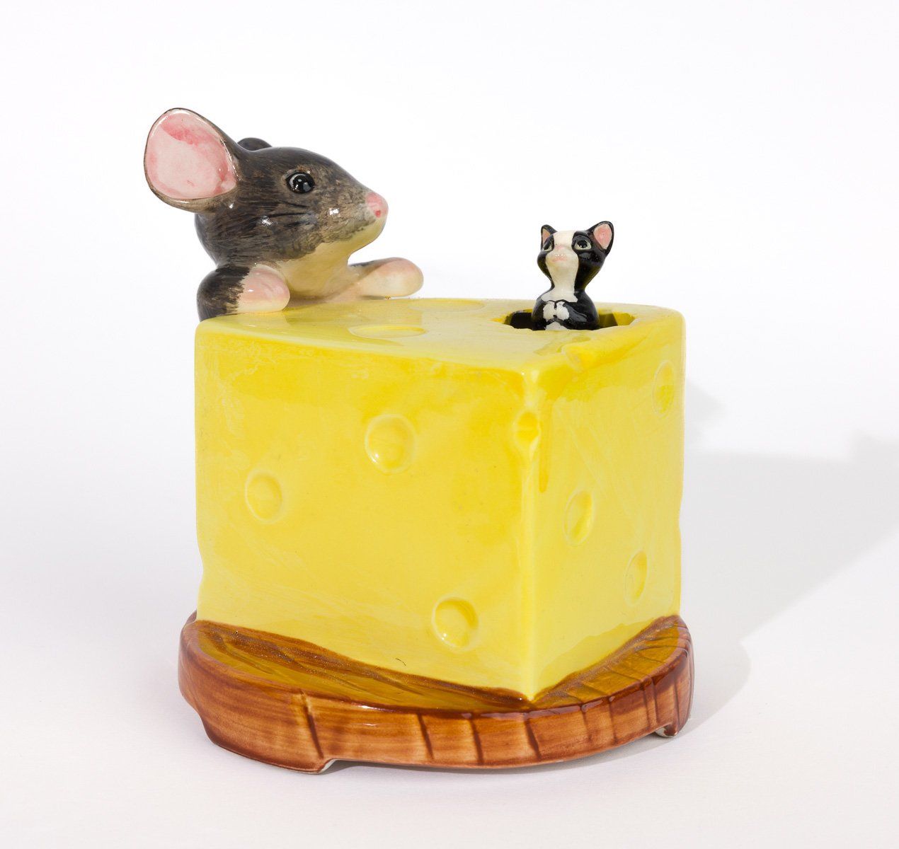 A mouse and a cat are sitting on a piece of cheese