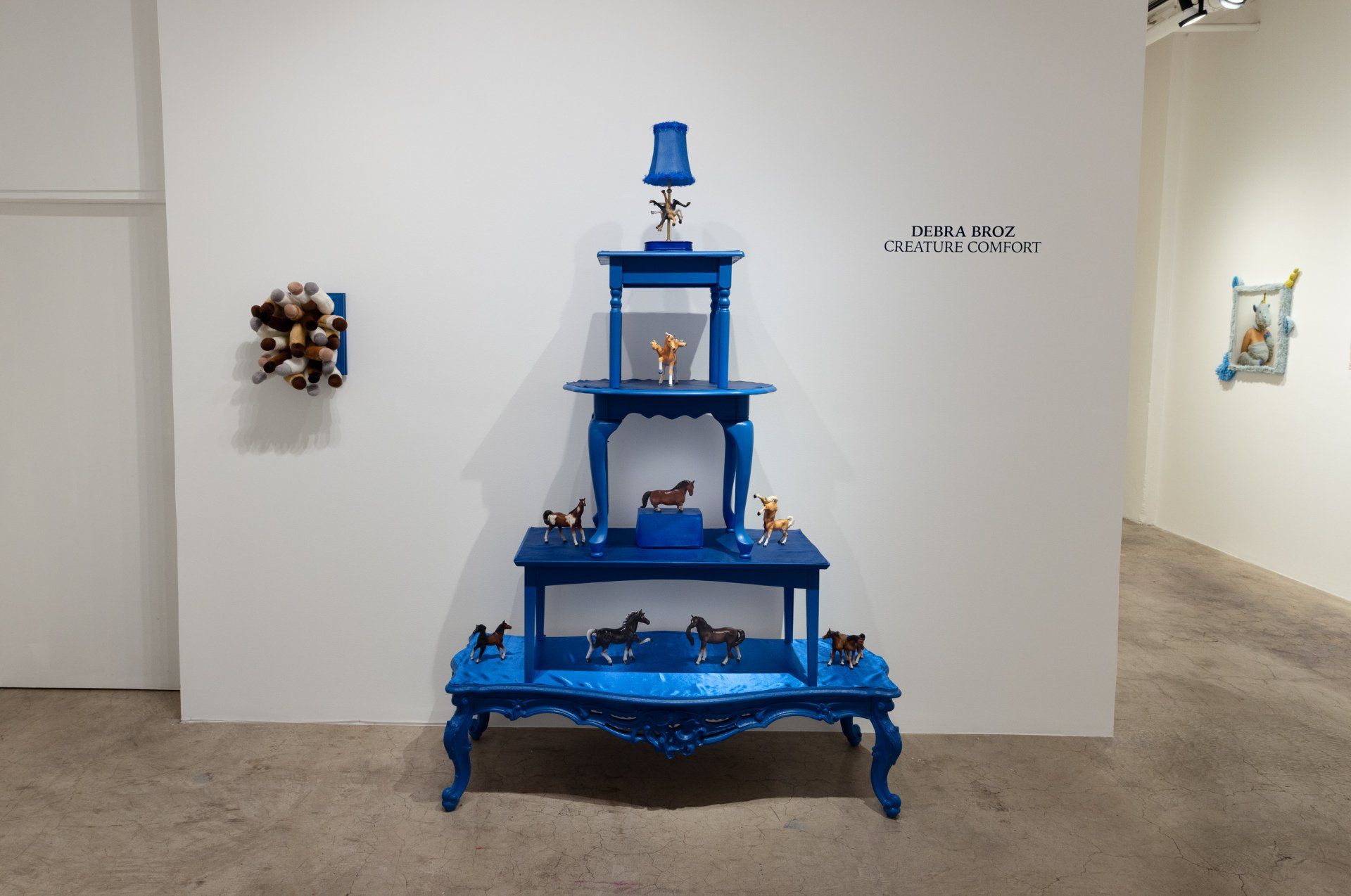 A blue table with a lamp on top of it in a room.