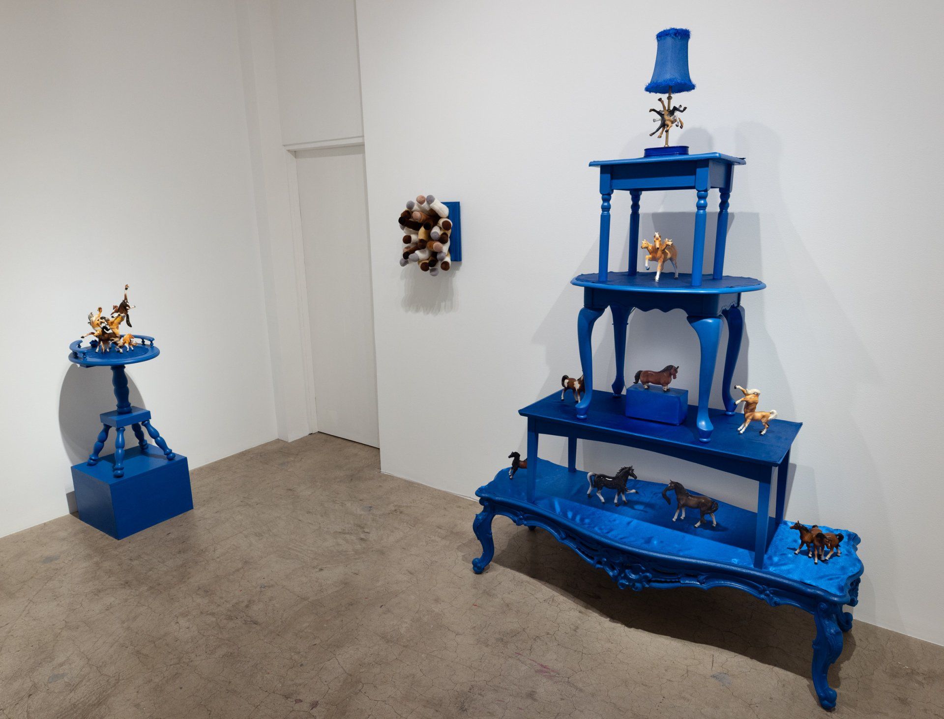 A room with blue tables and a lamp on top of them.