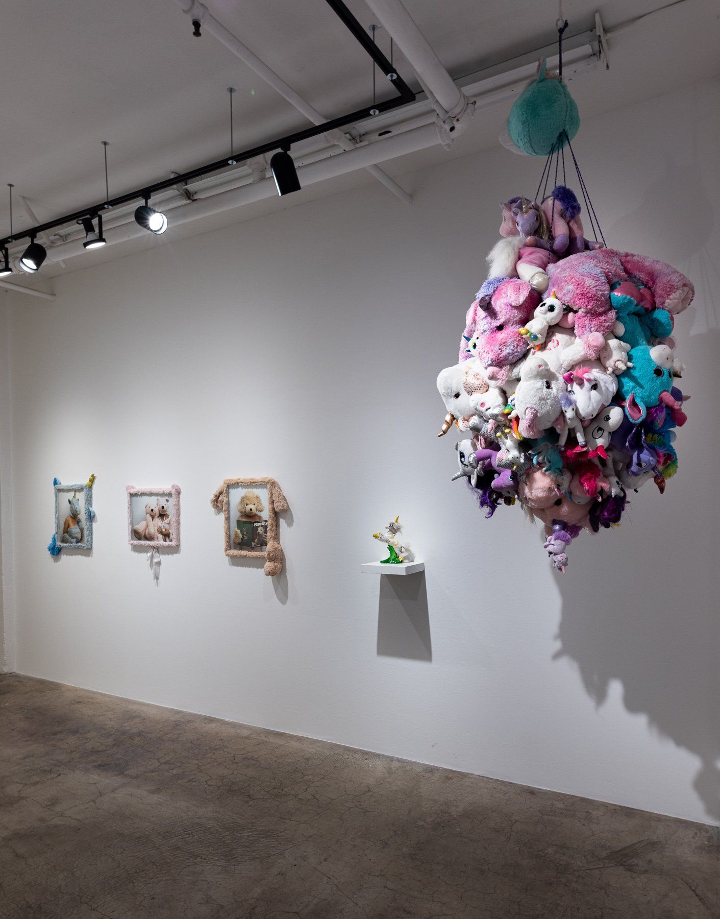 A room with a bunch of stuffed animals hanging from the ceiling