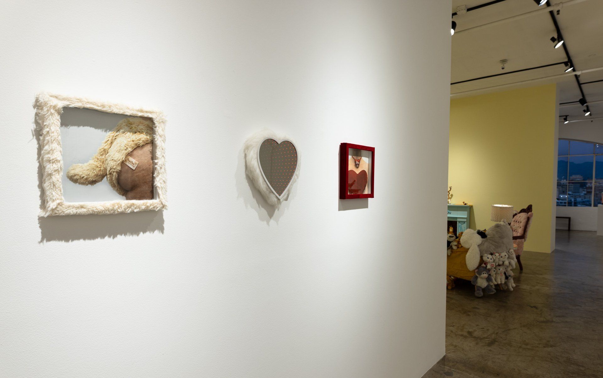 There are three paintings on the wall in a room.
