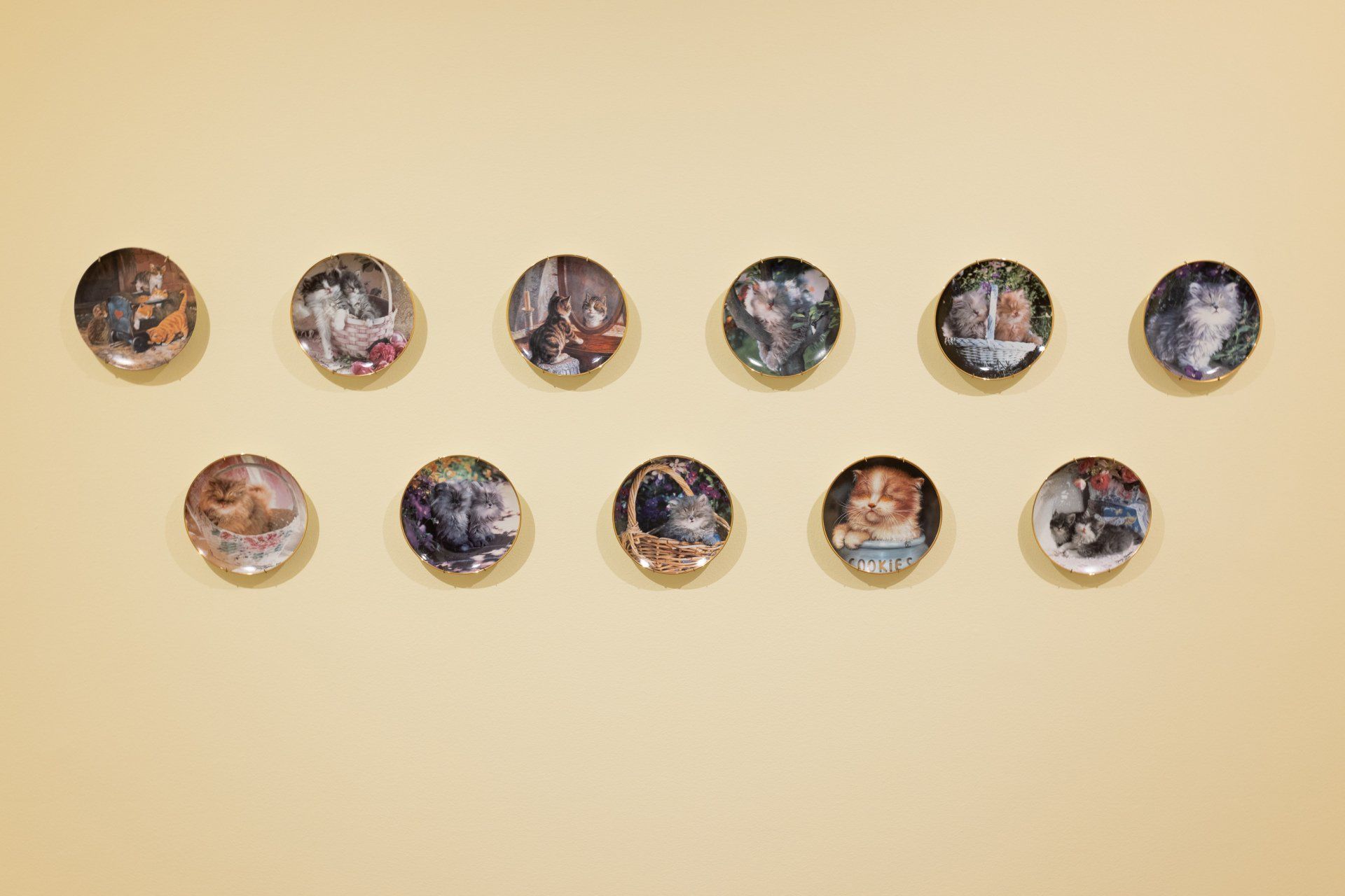 A group of buttons with pictures on them are lined up on a wall.