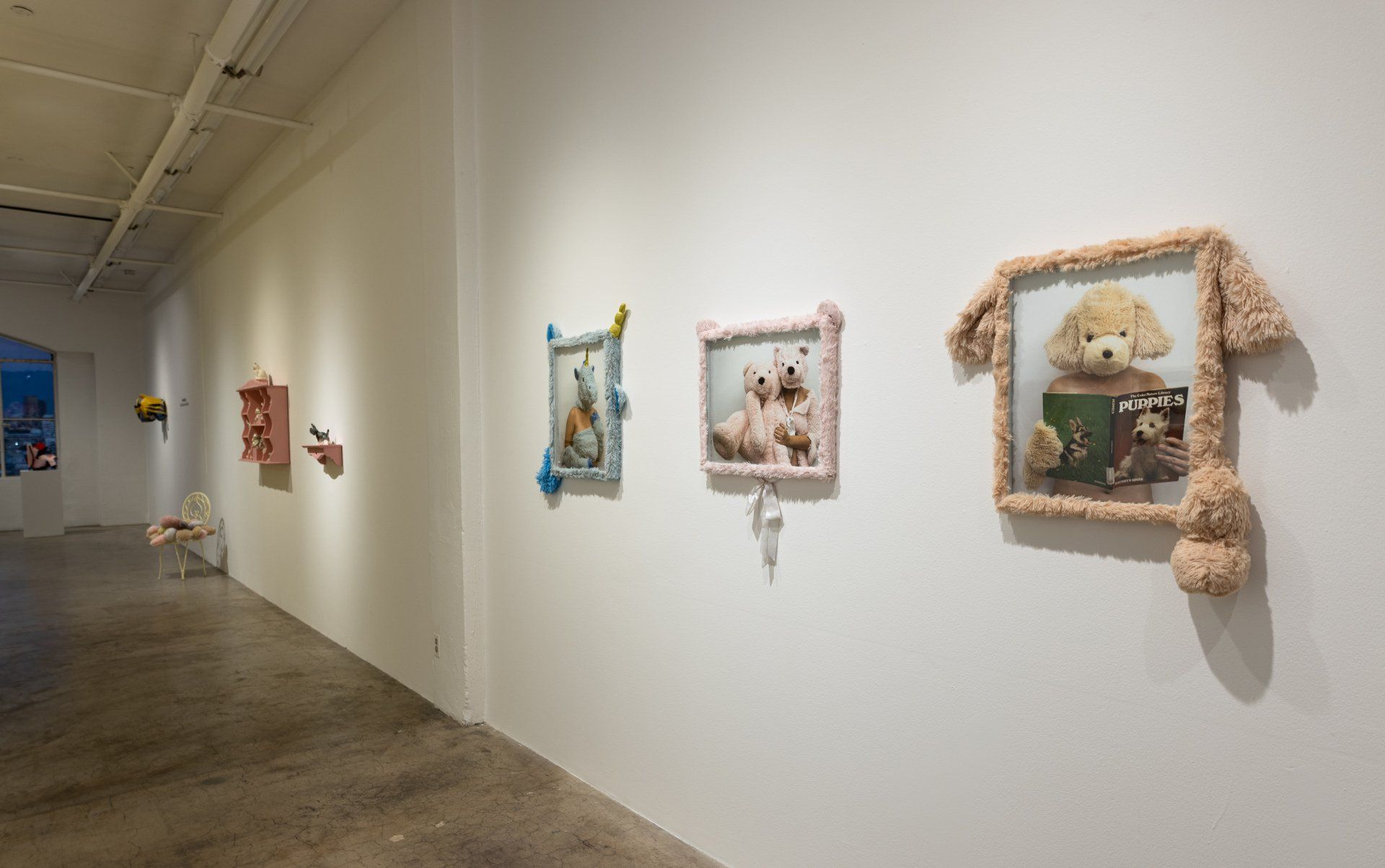 A hallway with a bunch of stuffed animals on the wall.