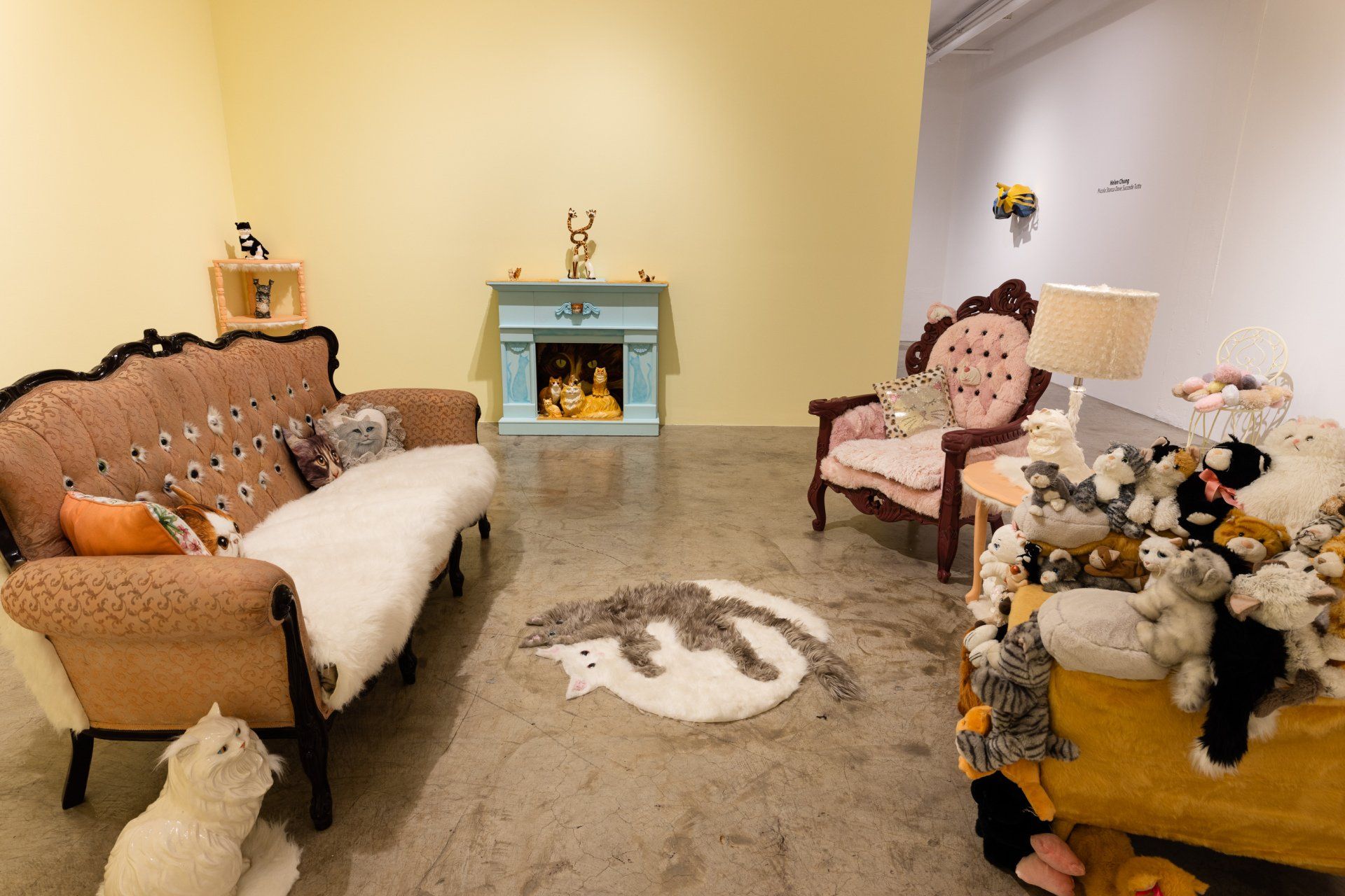 A living room with a couch , chairs , and a fireplace filled with stuffed animals.