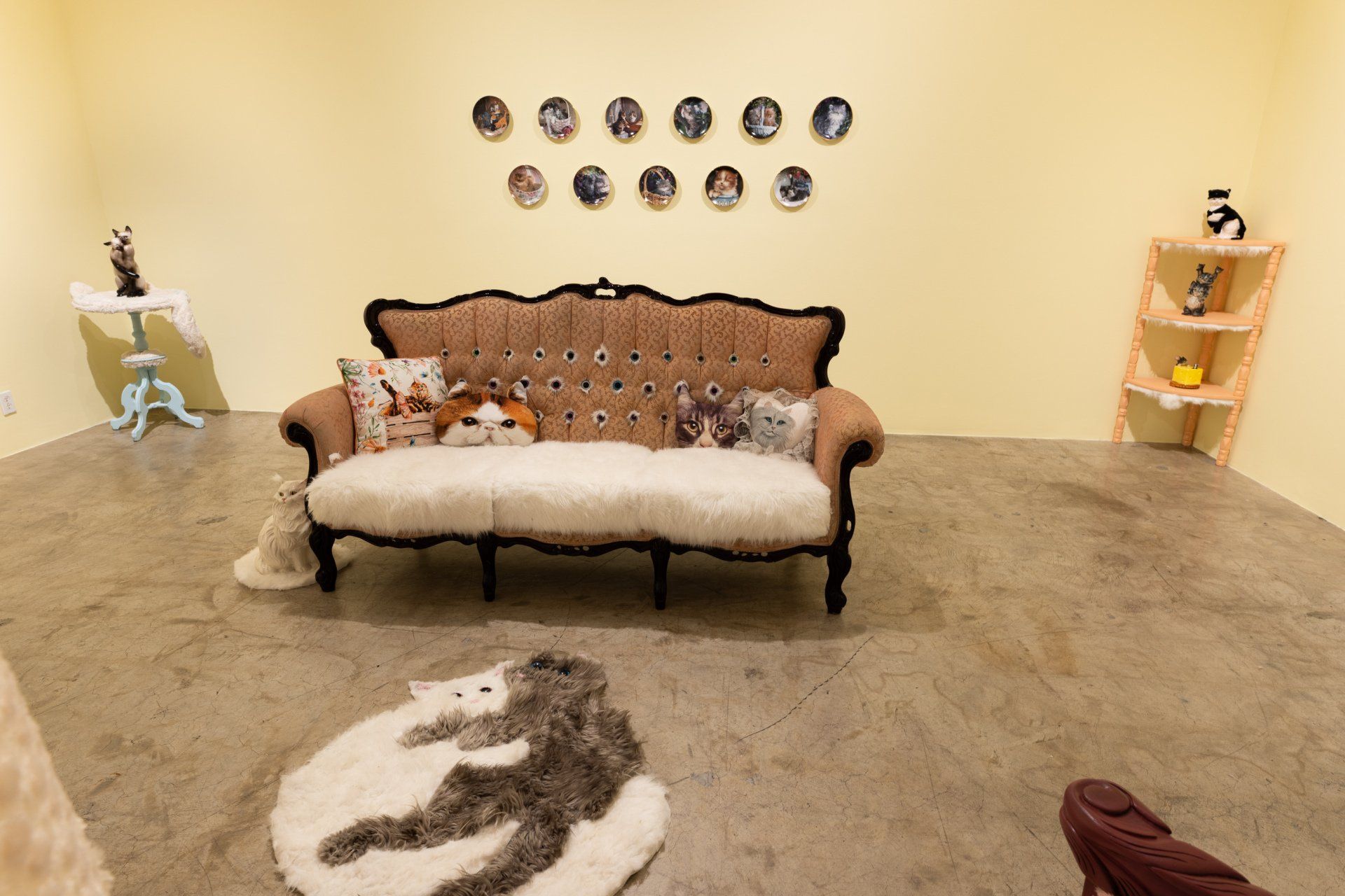 A room with a couch and a rug with a wolf on it.