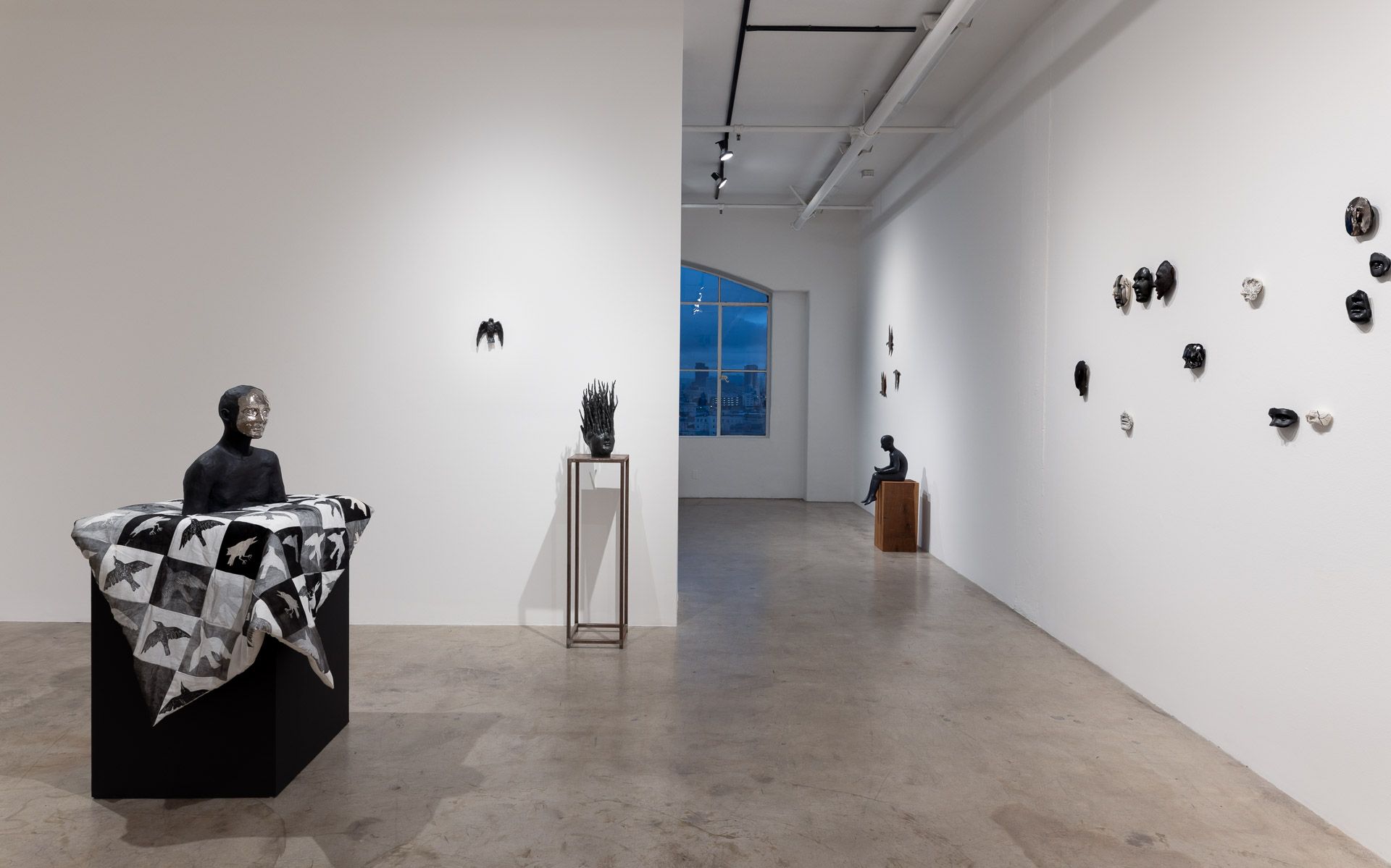 A large room with a lot of sculptures on the walls.