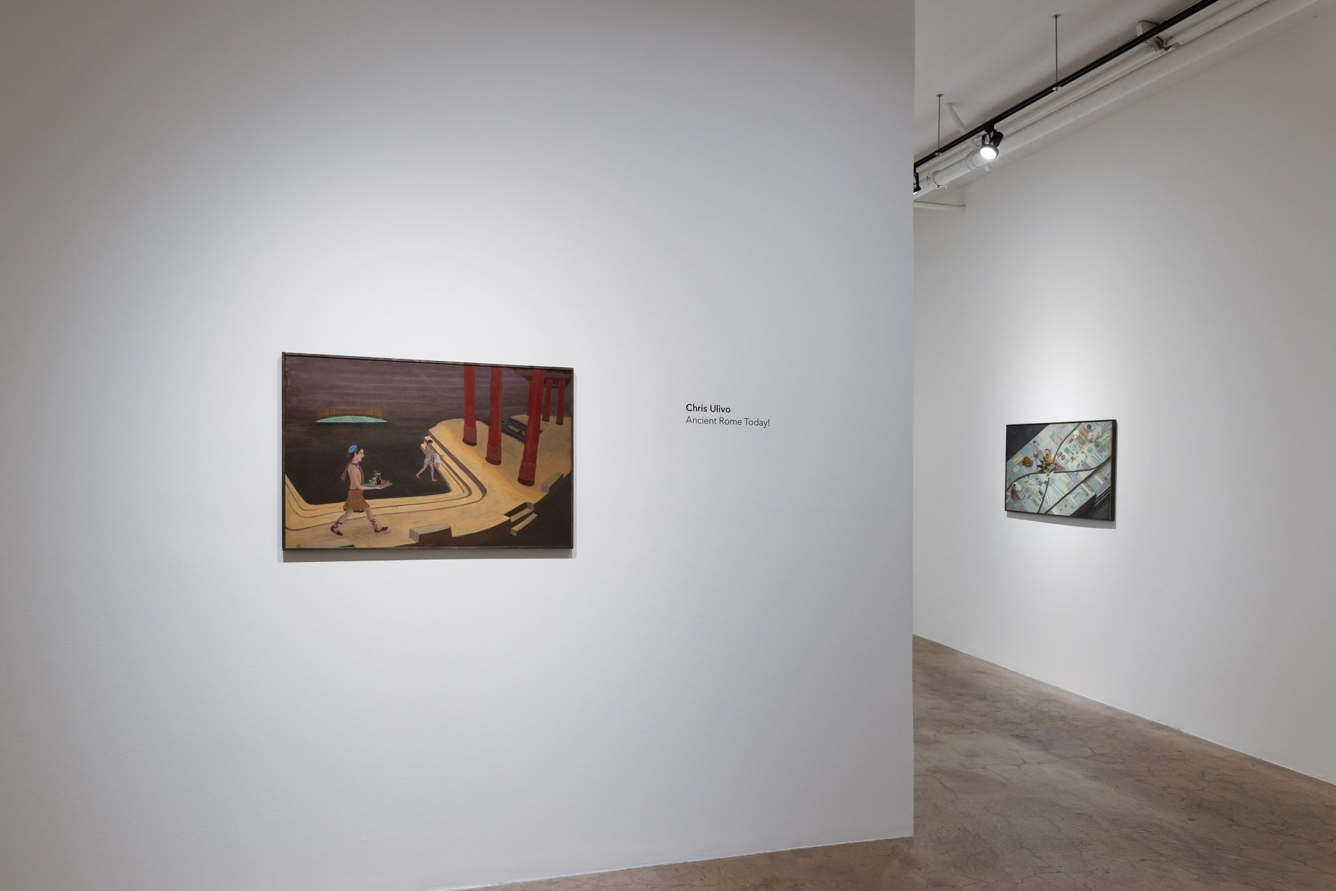 A room with a painting on the wall and a painting on the floor.
