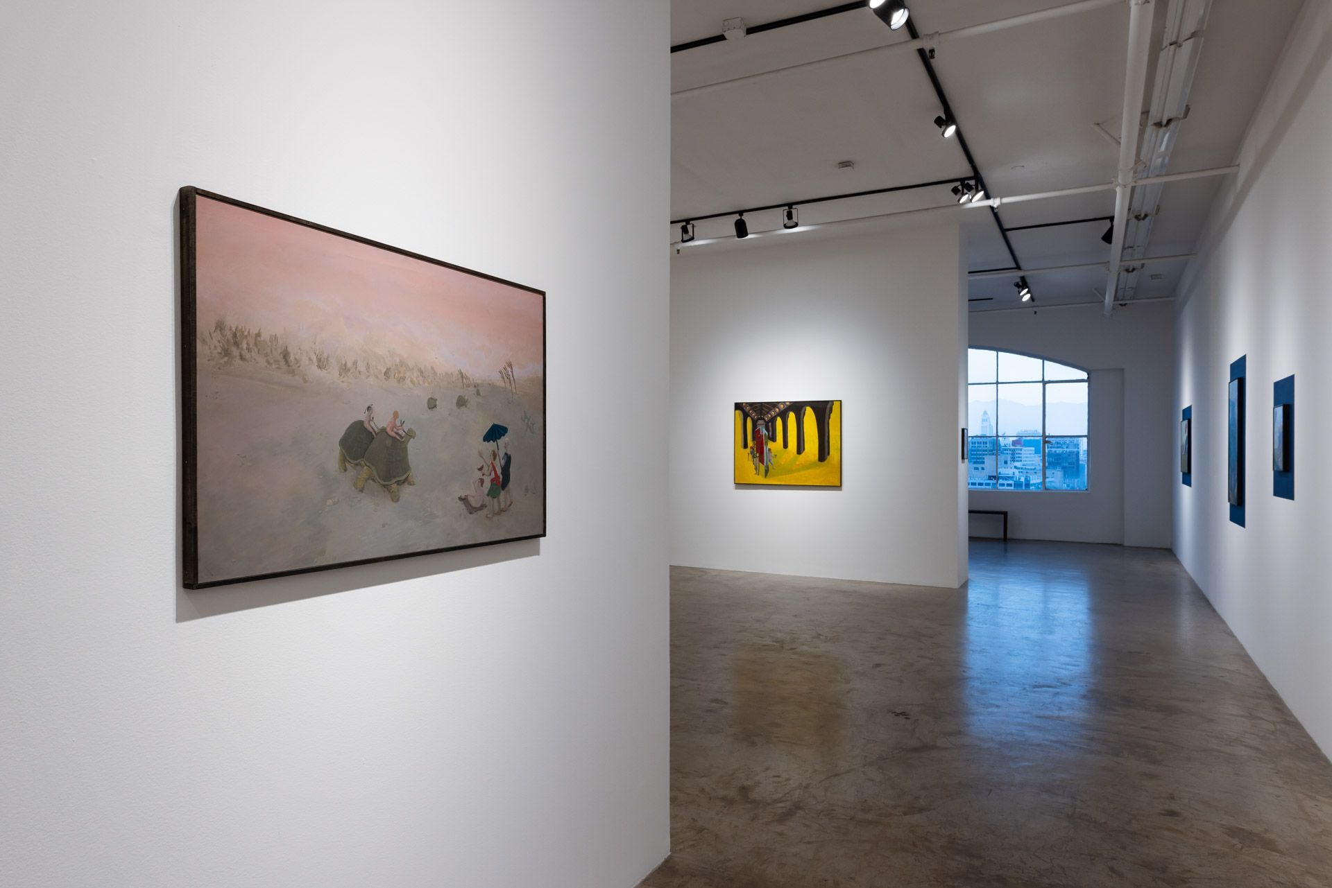 A painting is hanging on a wall in a museum