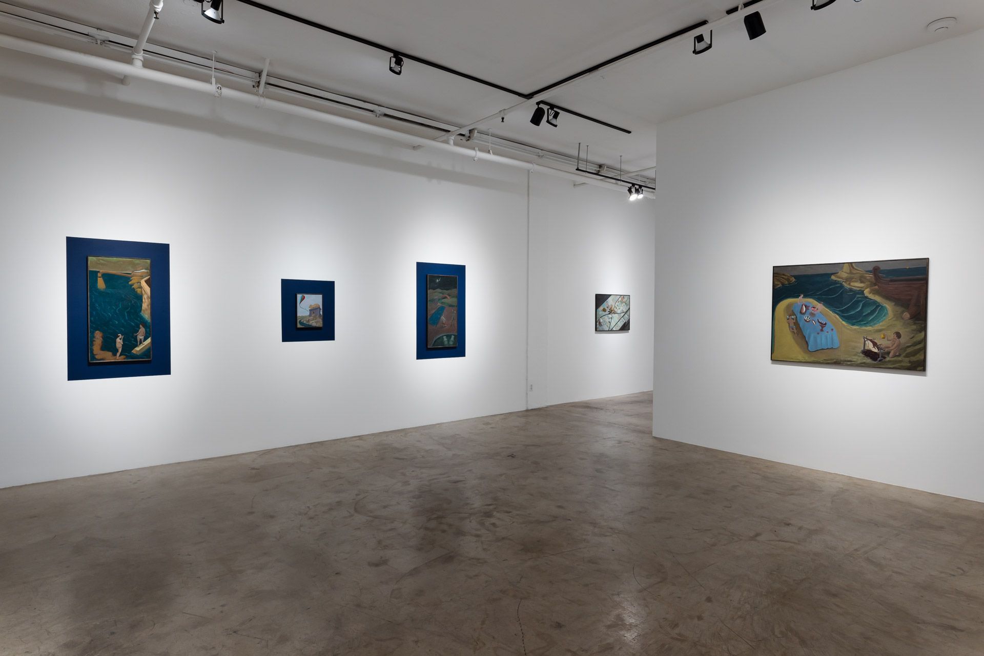 There are a lot of paintings on the wall in this room.