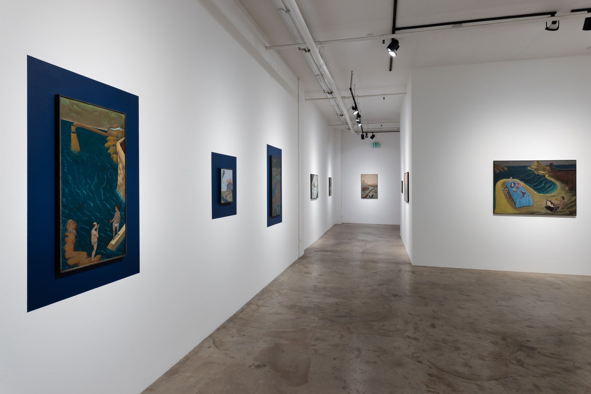 A long hallway with paintings on the wall in a museum