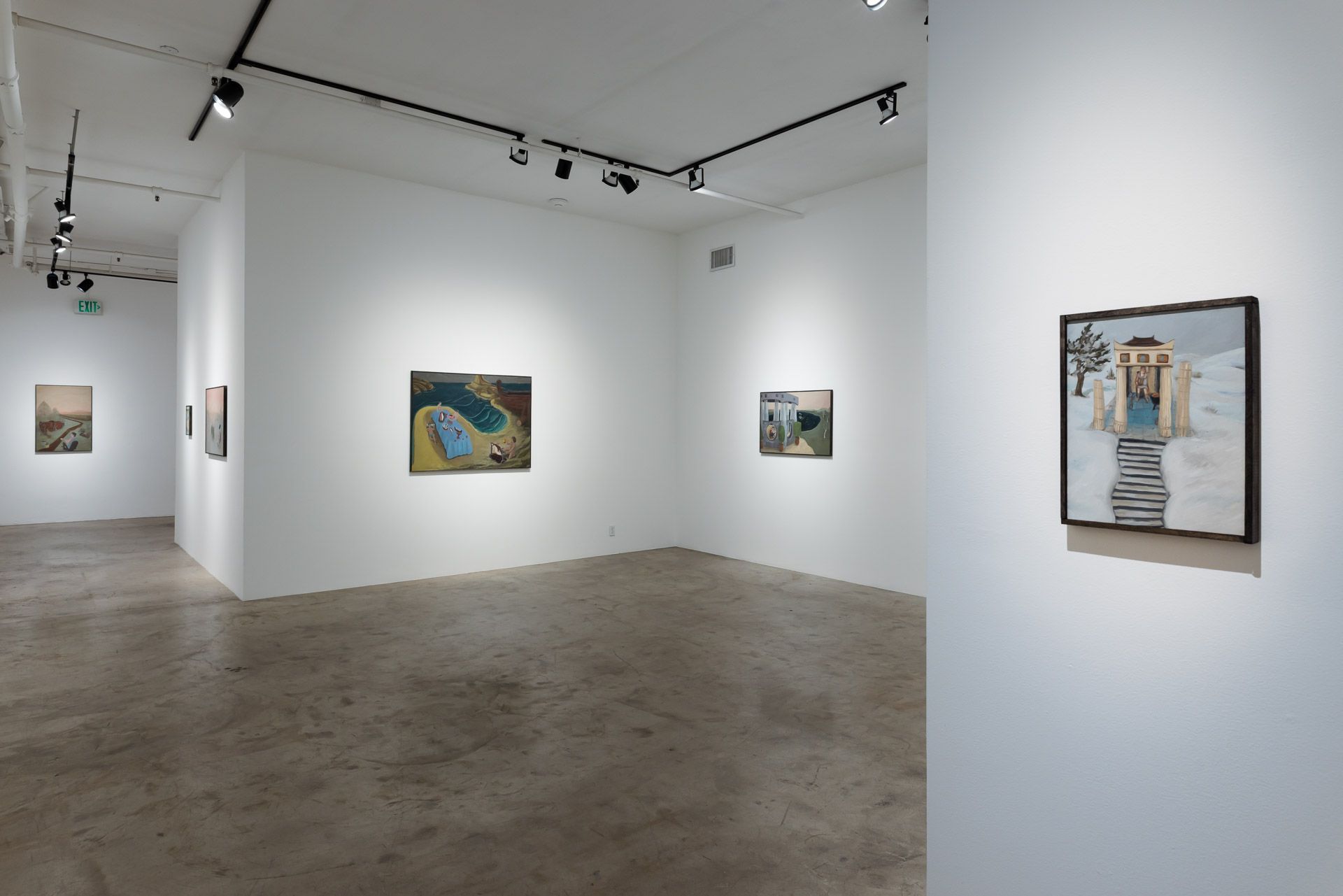 A room with a lot of paintings on the walls