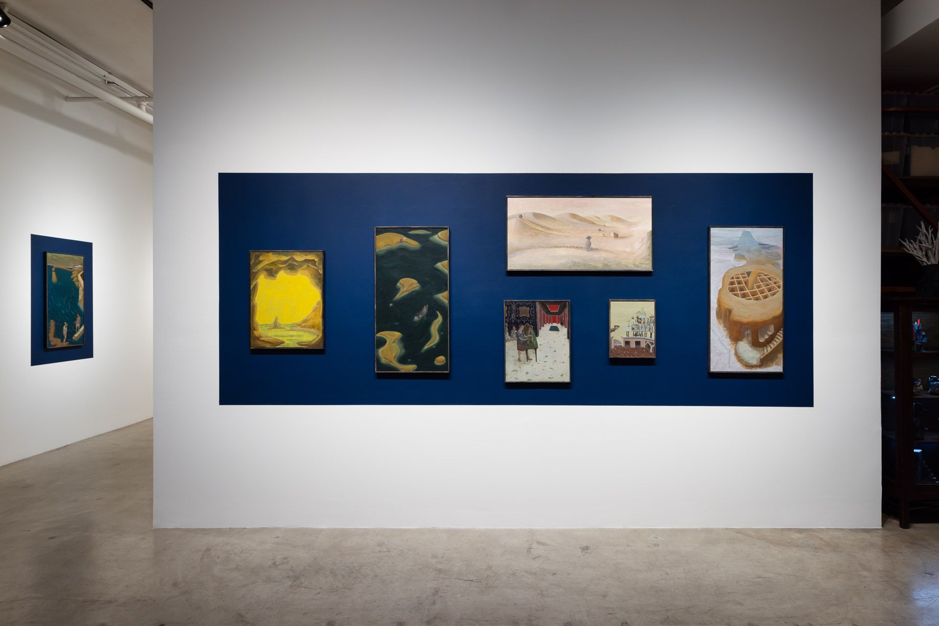A room with a lot of paintings on the wall.