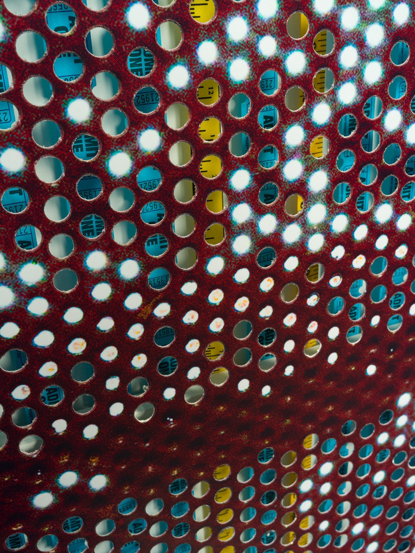 A close up of a polka dot pattern on a red surface
