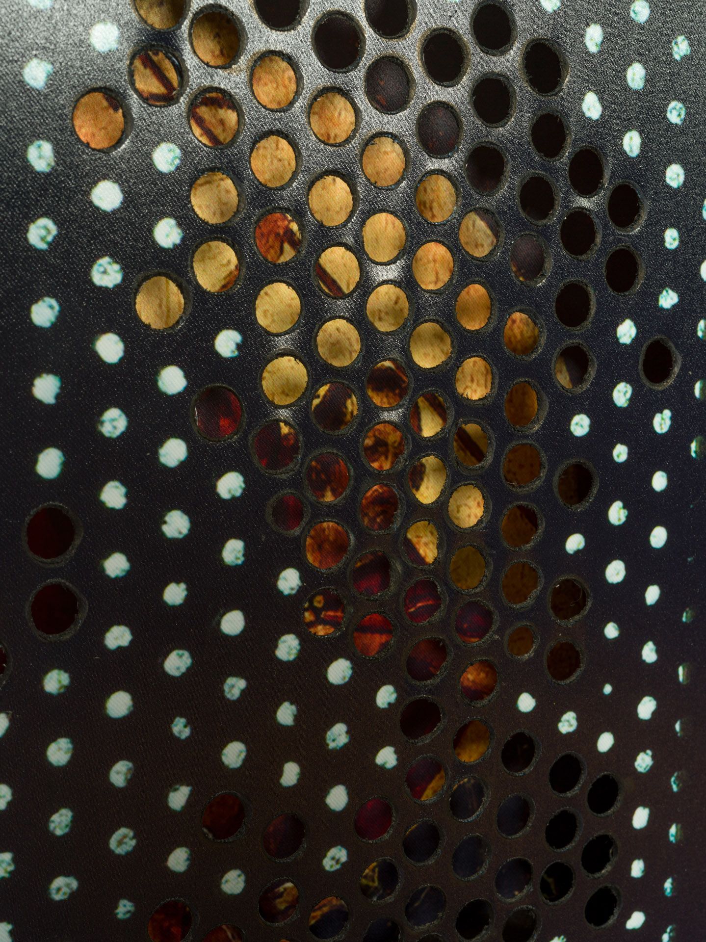 A close up of a metal surface with holes in it