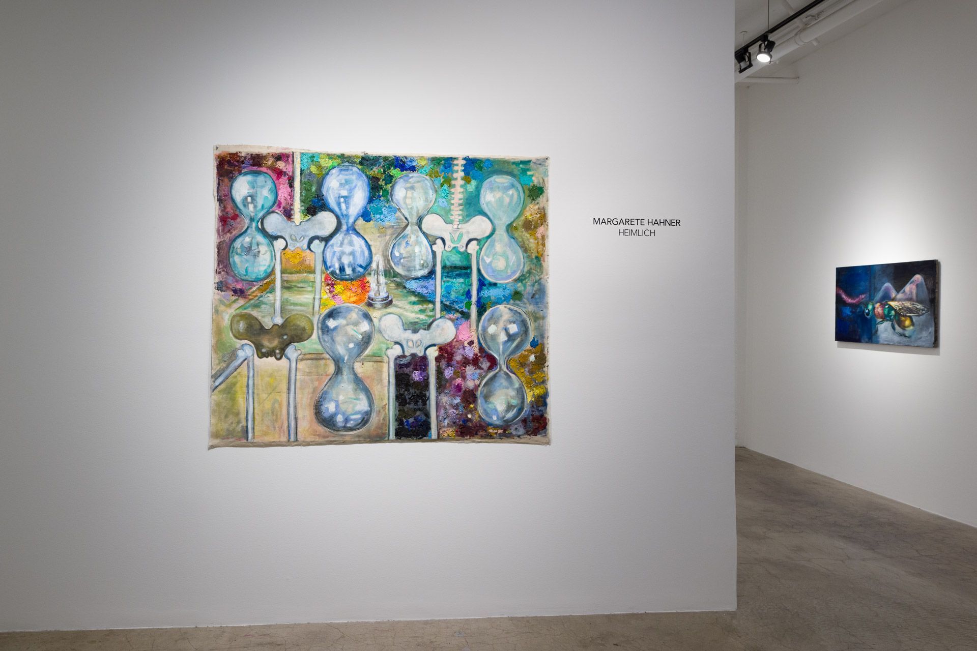 A painting is hanging on a white wall in a museum.