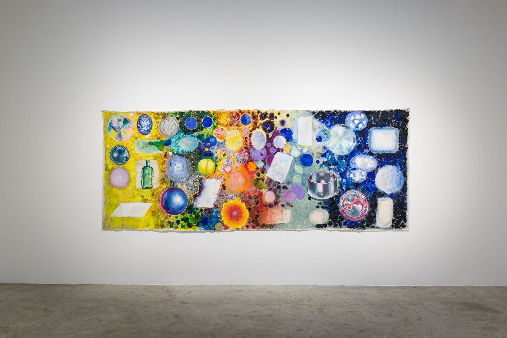 Colorful abstract painting with bright circles and geometric shapes on a white gallery wall