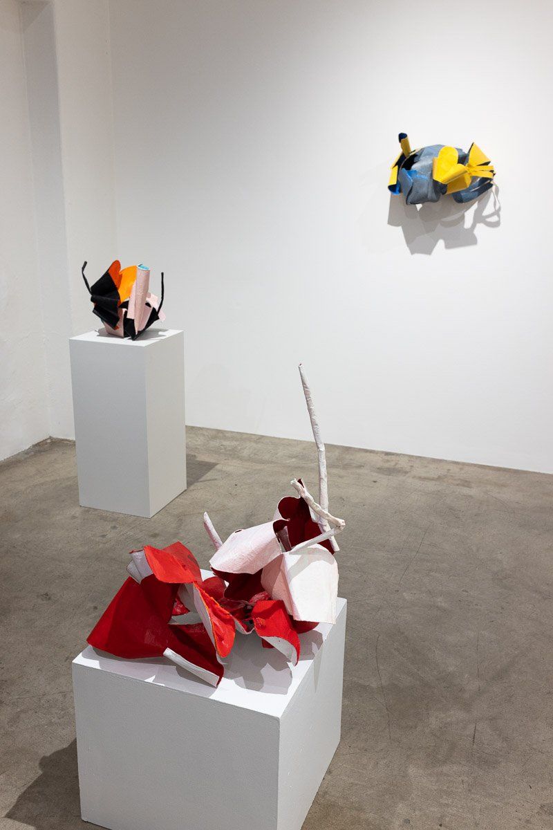 A room with a bunch of sculptures on display