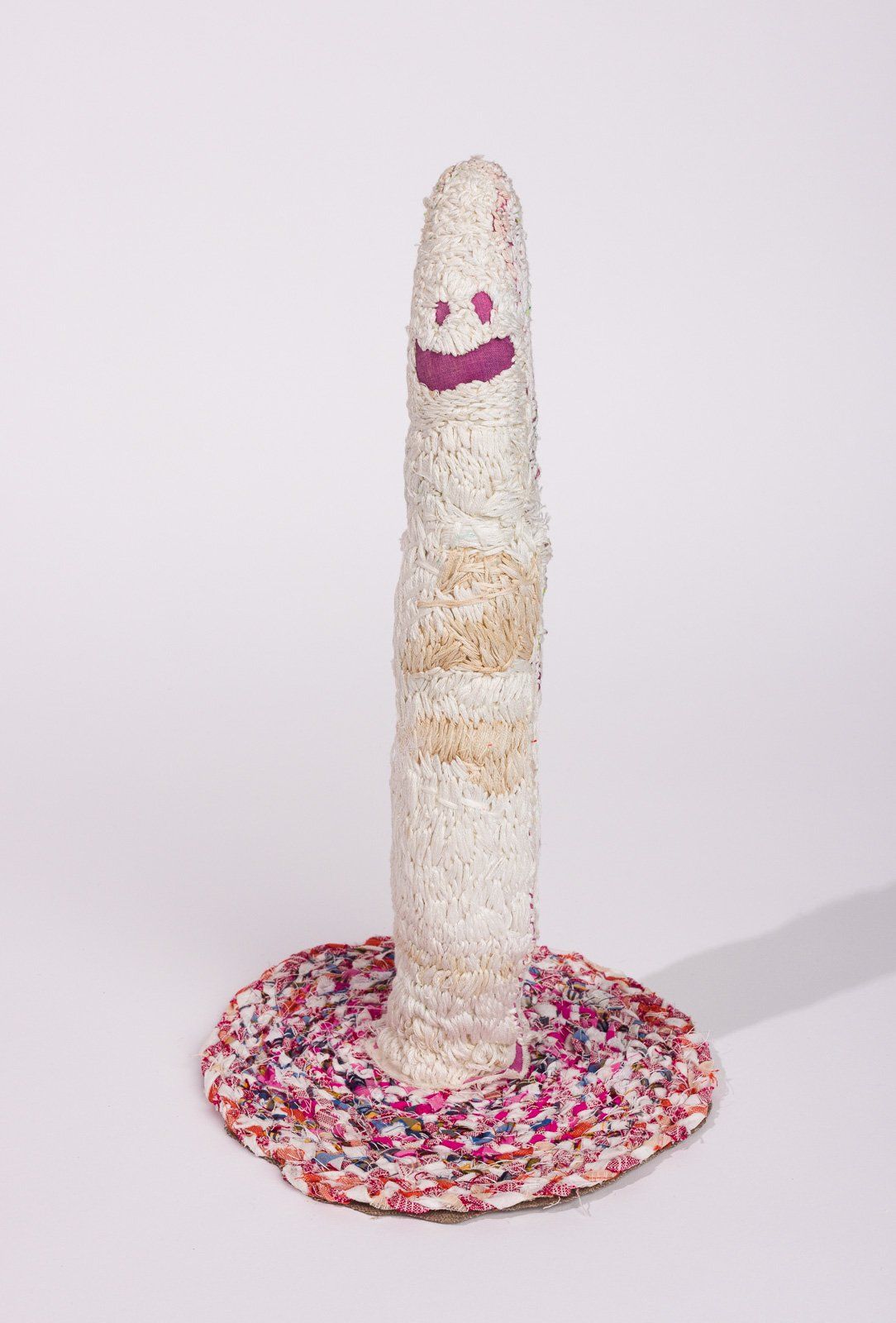 A sculpture of a worm with a smiley face on it.