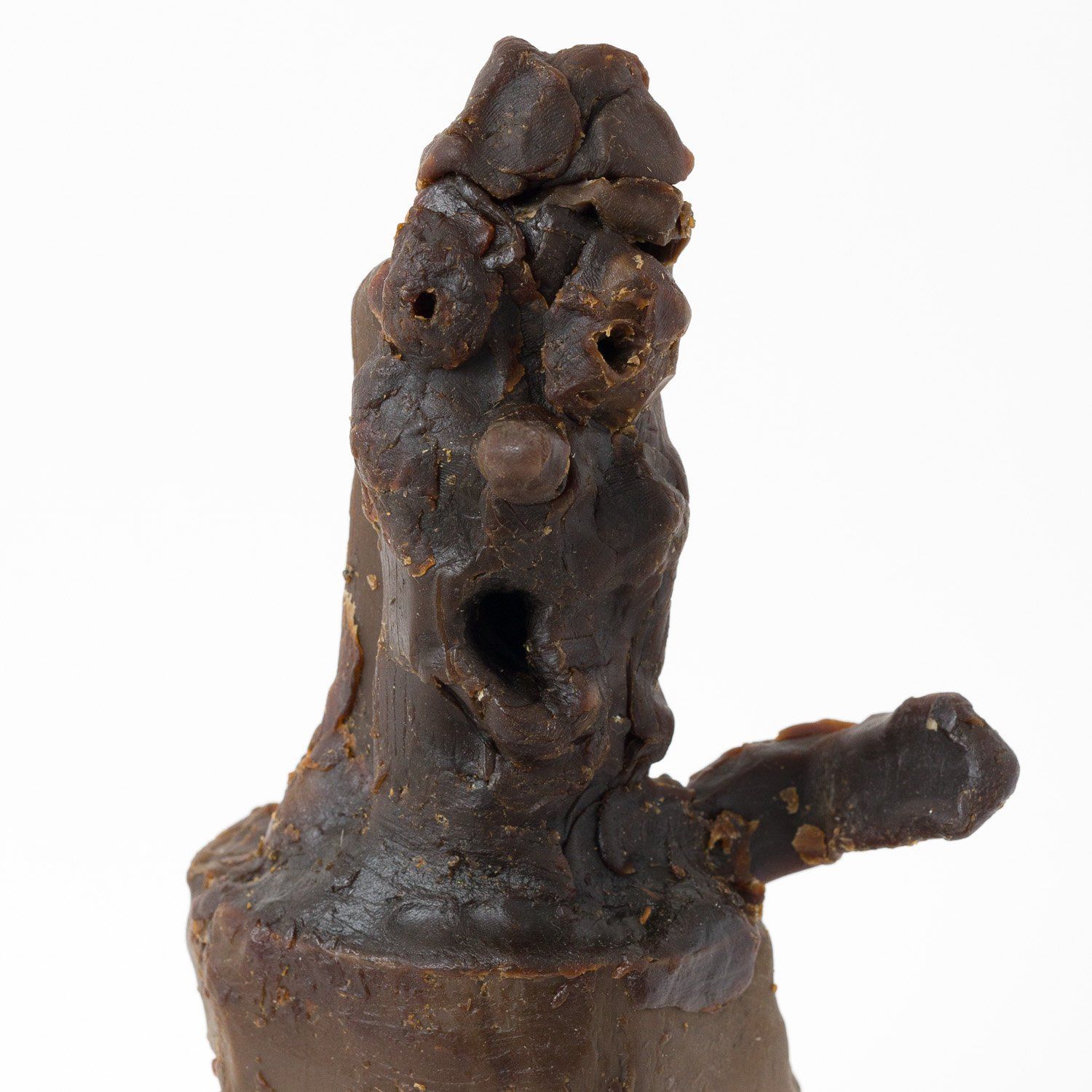A close up of a statue with a face on it