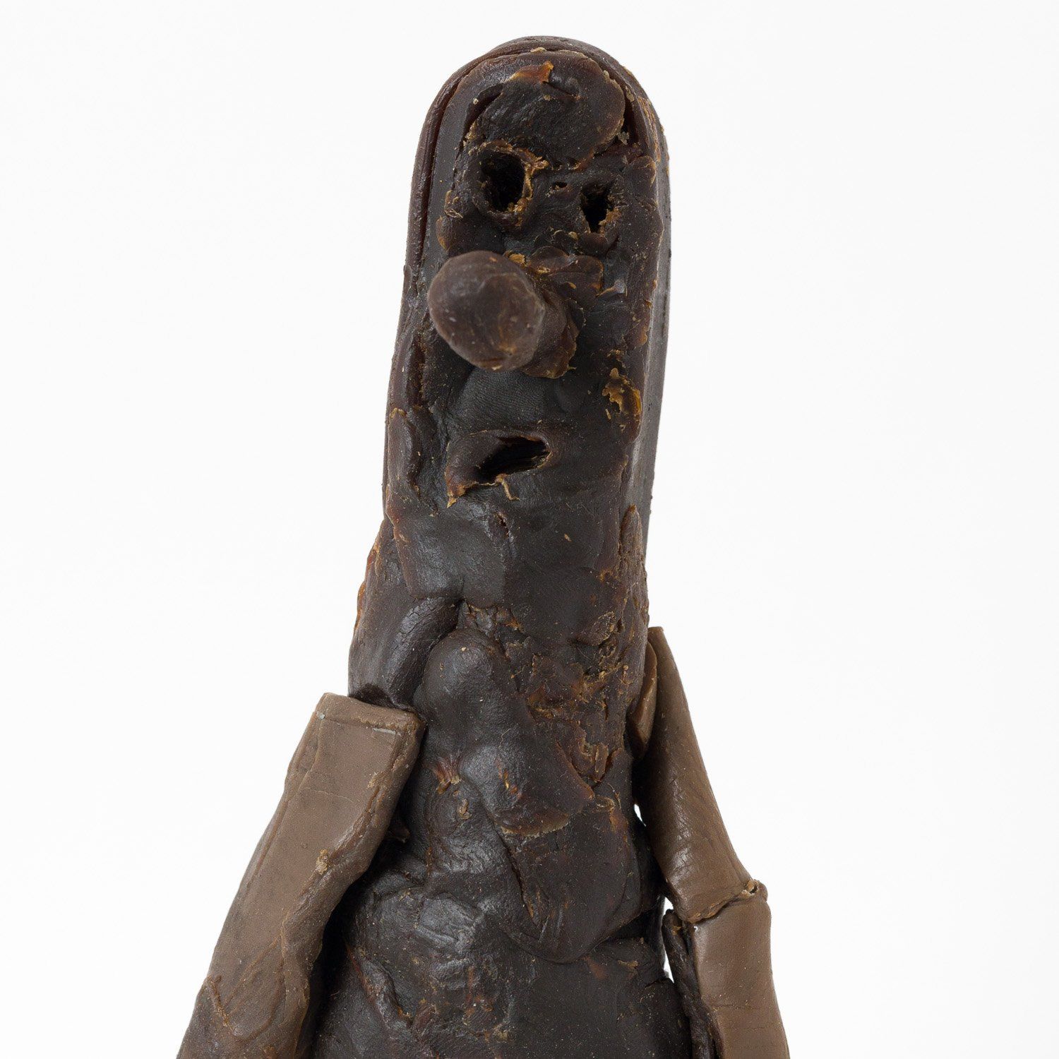A close up of a statue with a face on it