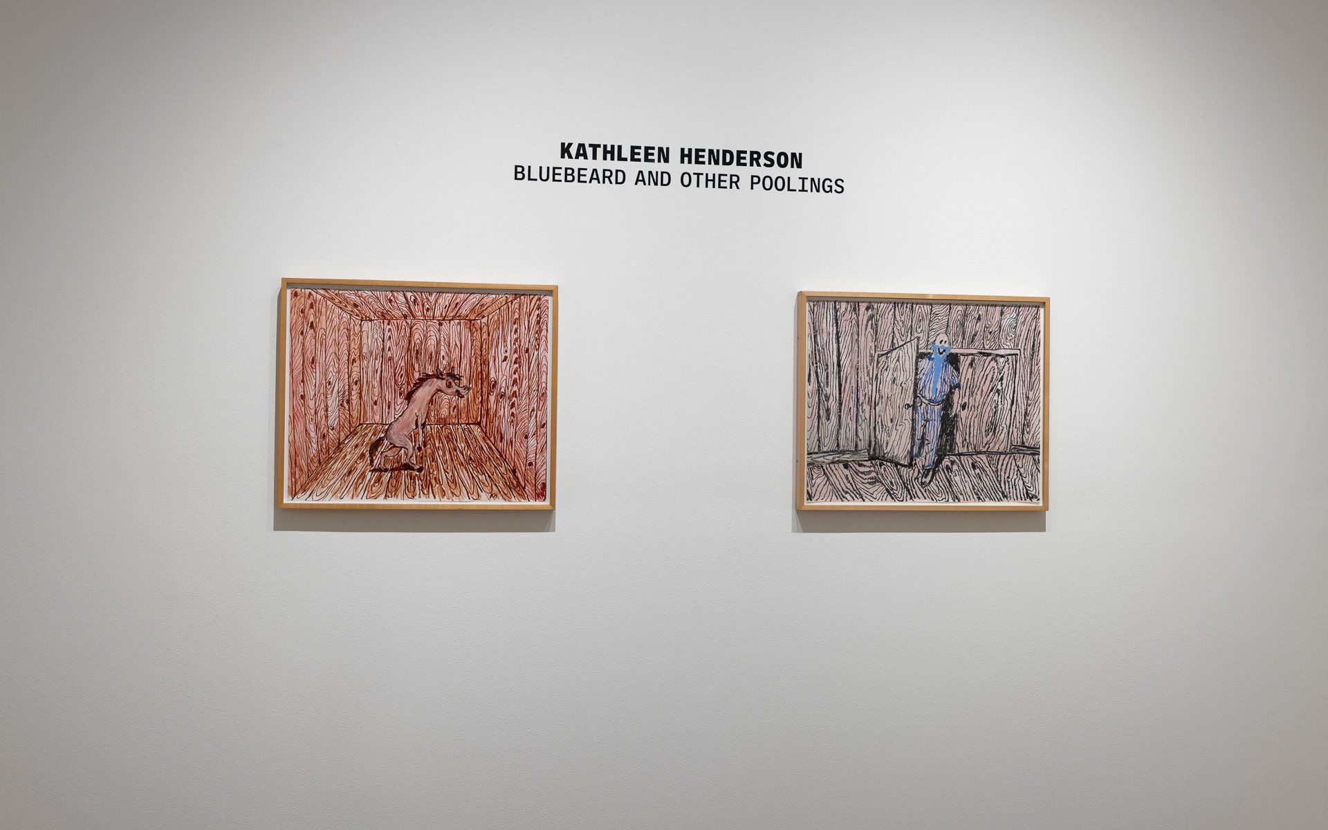 Two framed paintings are hanging on a white wall.