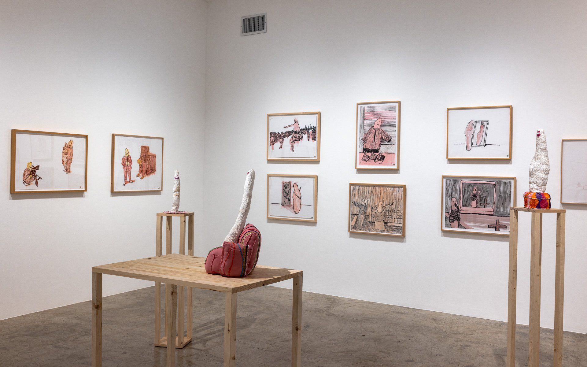 A room with a table and paintings on the wall