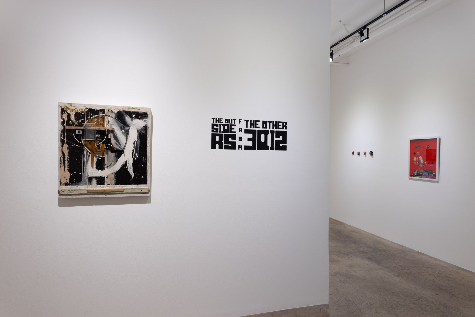 A painting is hanging on a white wall in a museum.