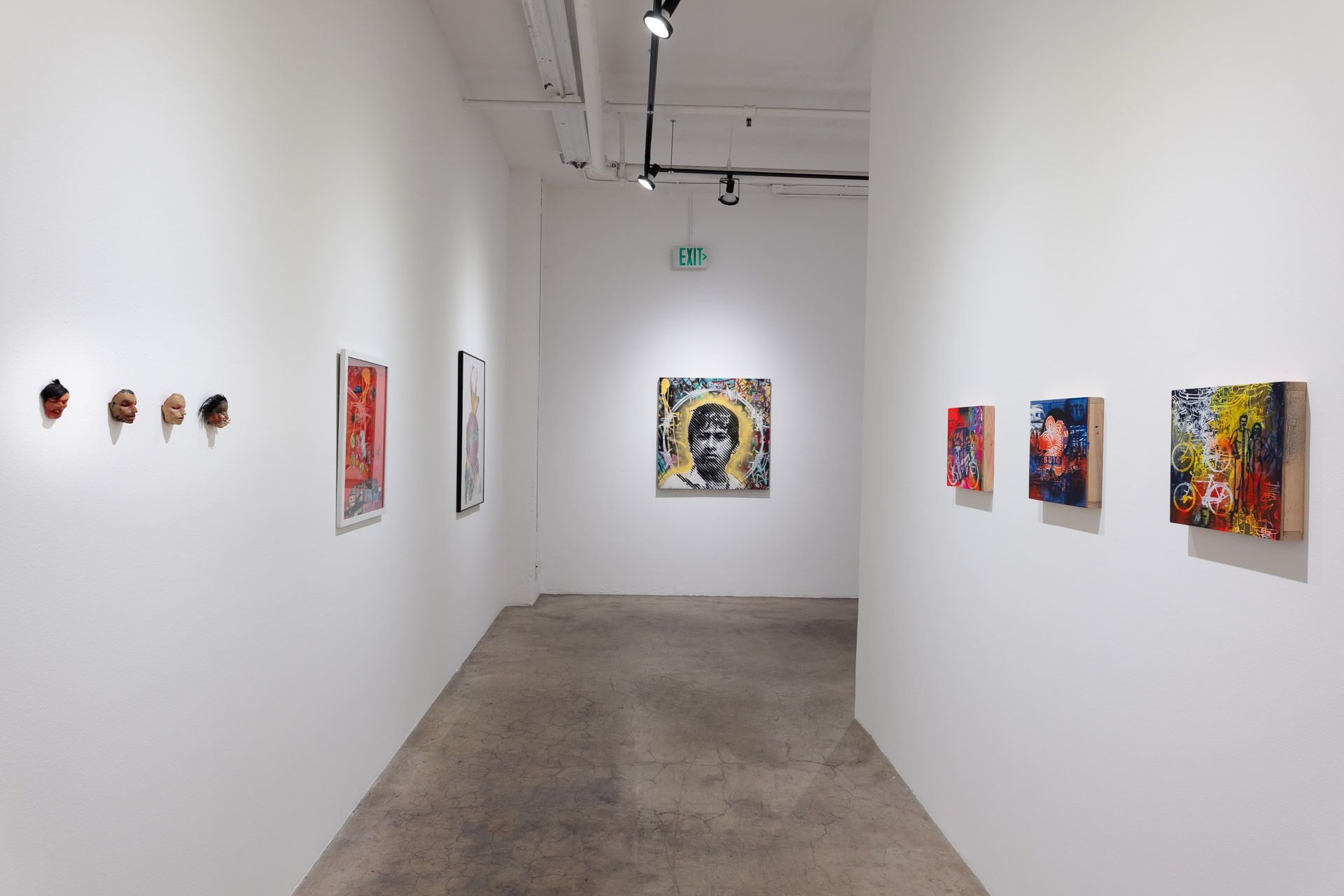 A long hallway with paintings on the wall in a museum.