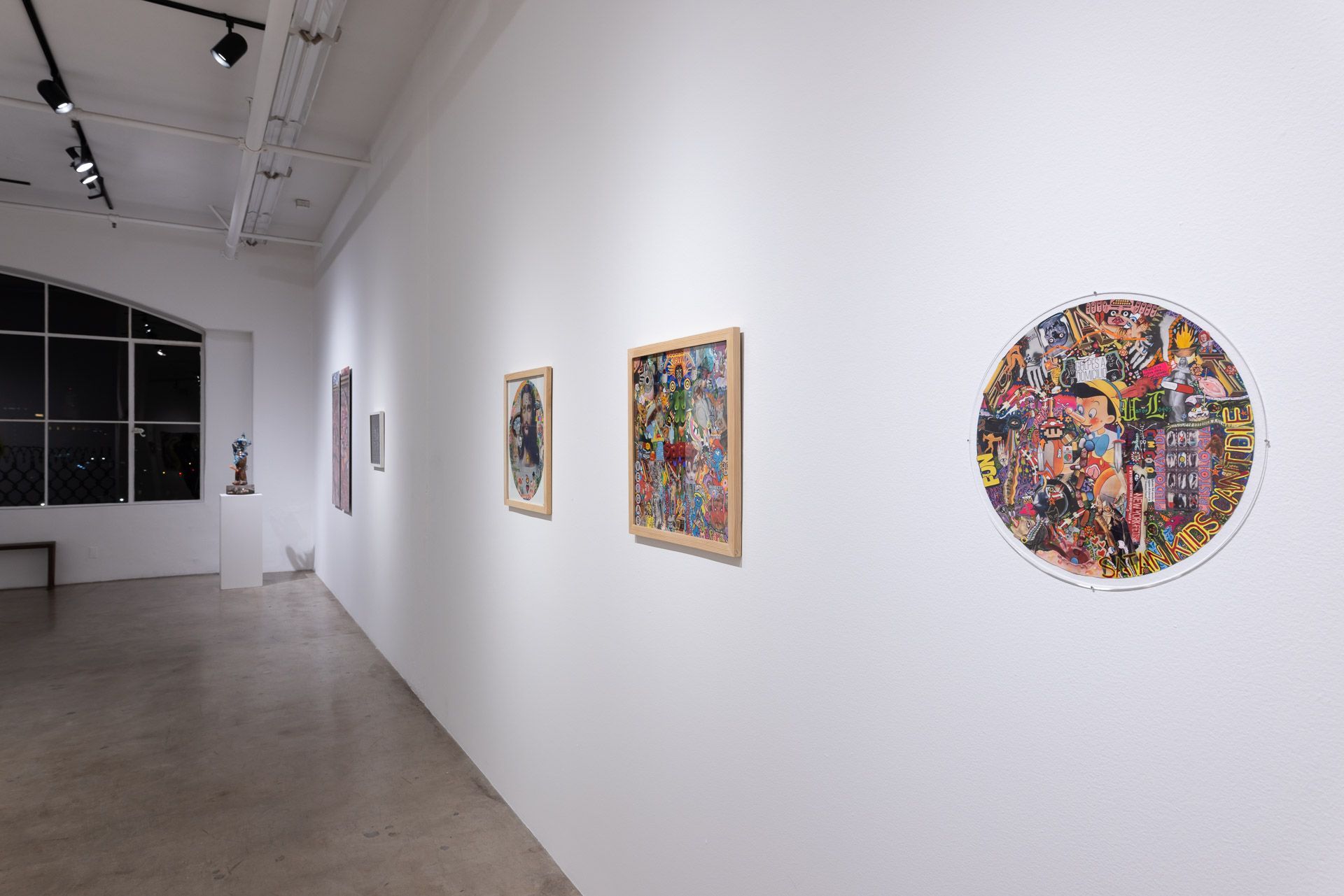 There are a lot of paintings on the wall in this room.